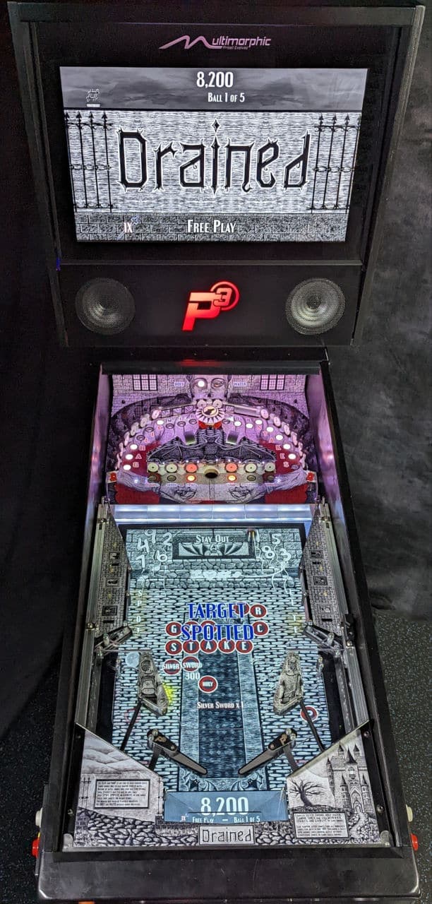 Drained pinball machine with gothic-themed playfield and score display