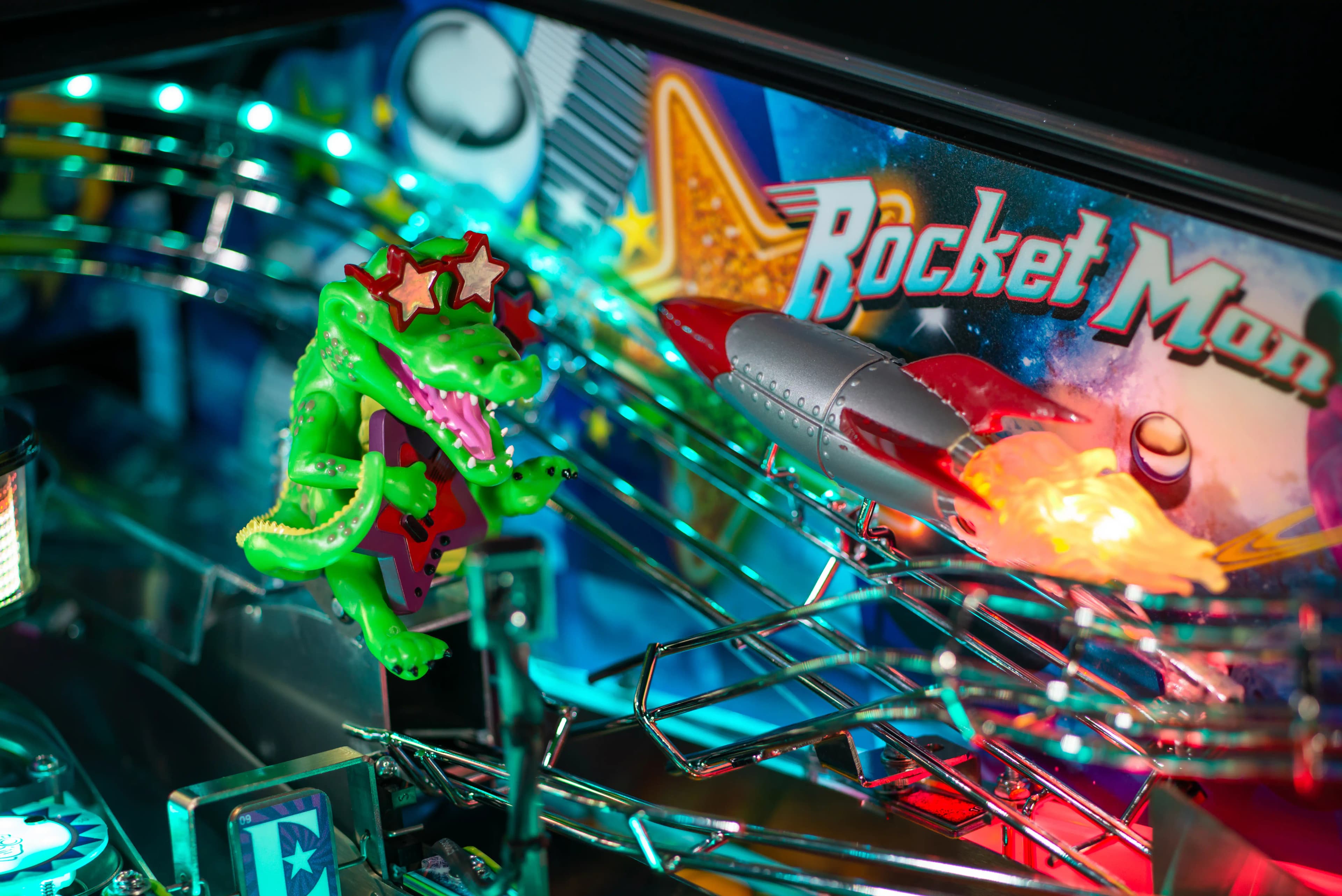 Colorful Rocket Man pinball machine with green lizard and rocket