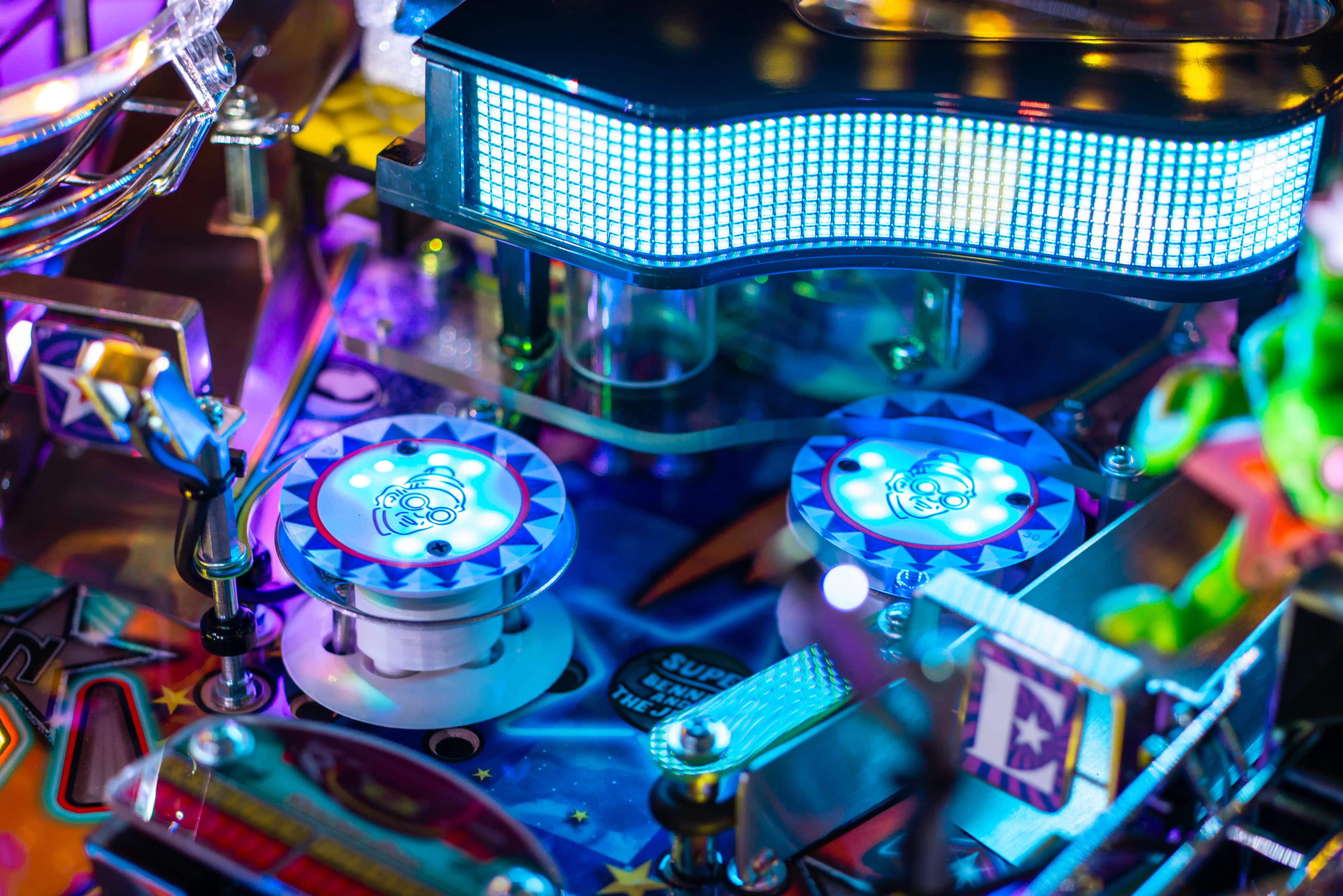 Colorful pinball machine with blue LED lights and decorative circular targets