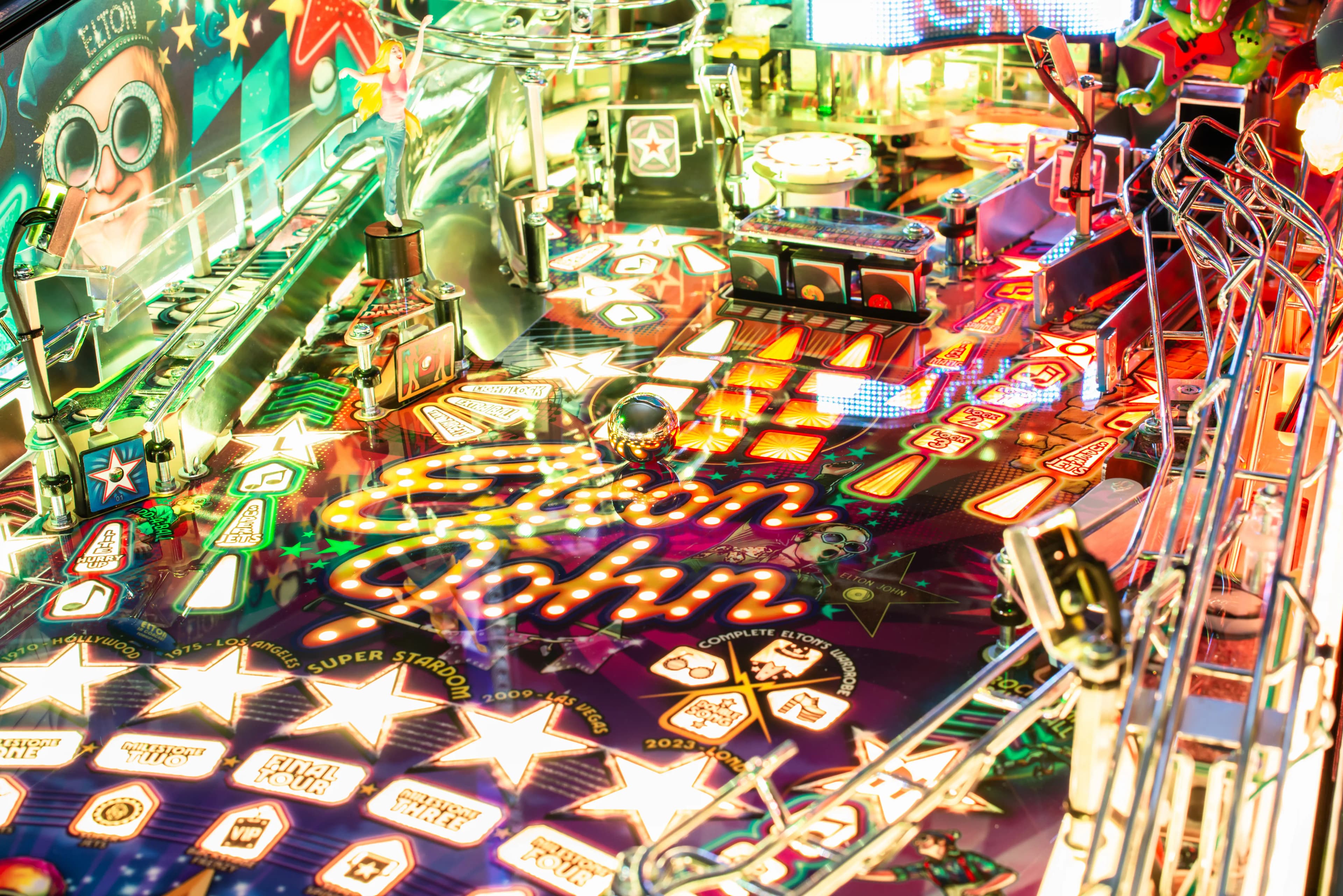 Colorful Elton John-themed pinball machine with vibrant lights and stars