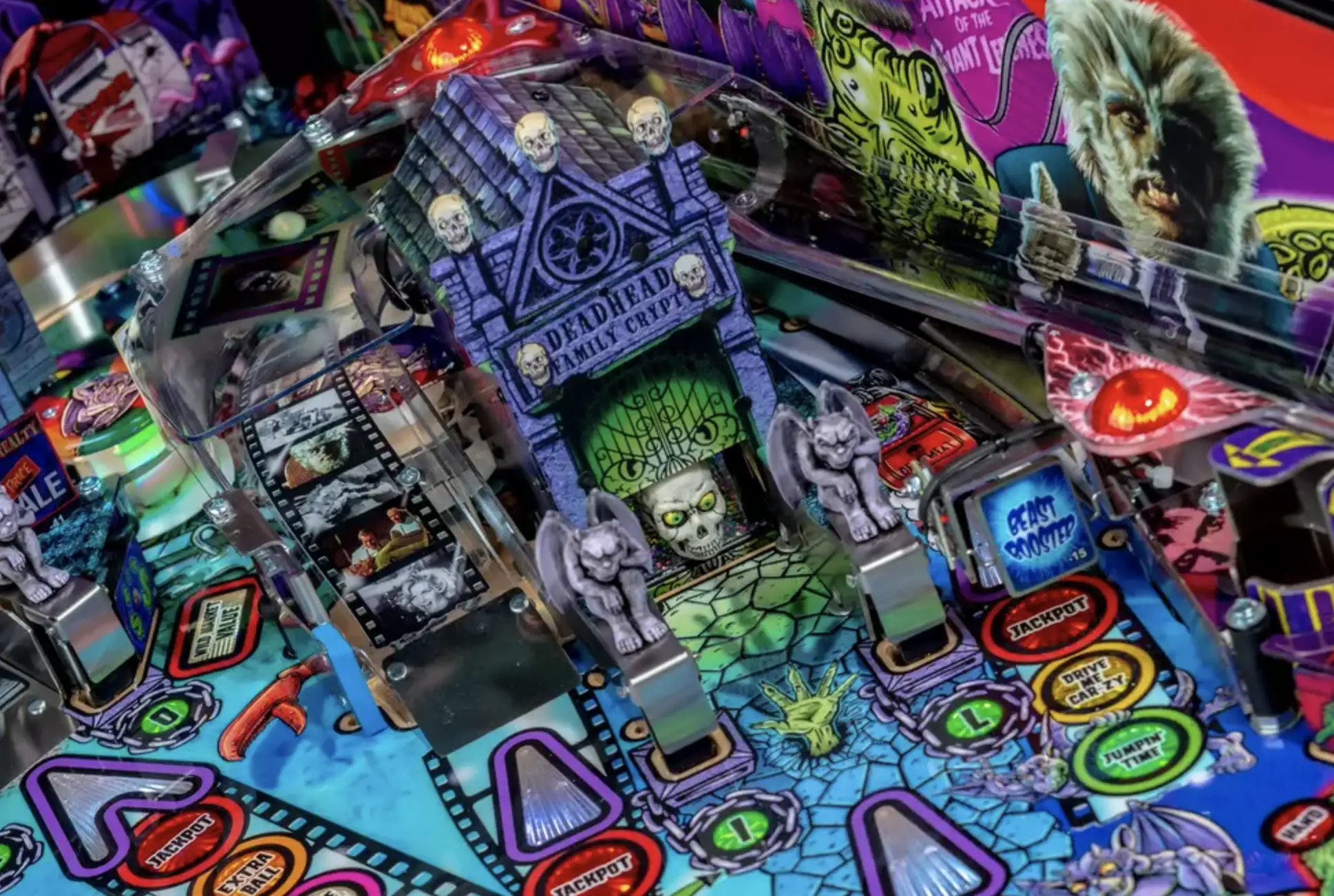 Colorful haunted house pinball machine with skulls, monsters, and spooky details