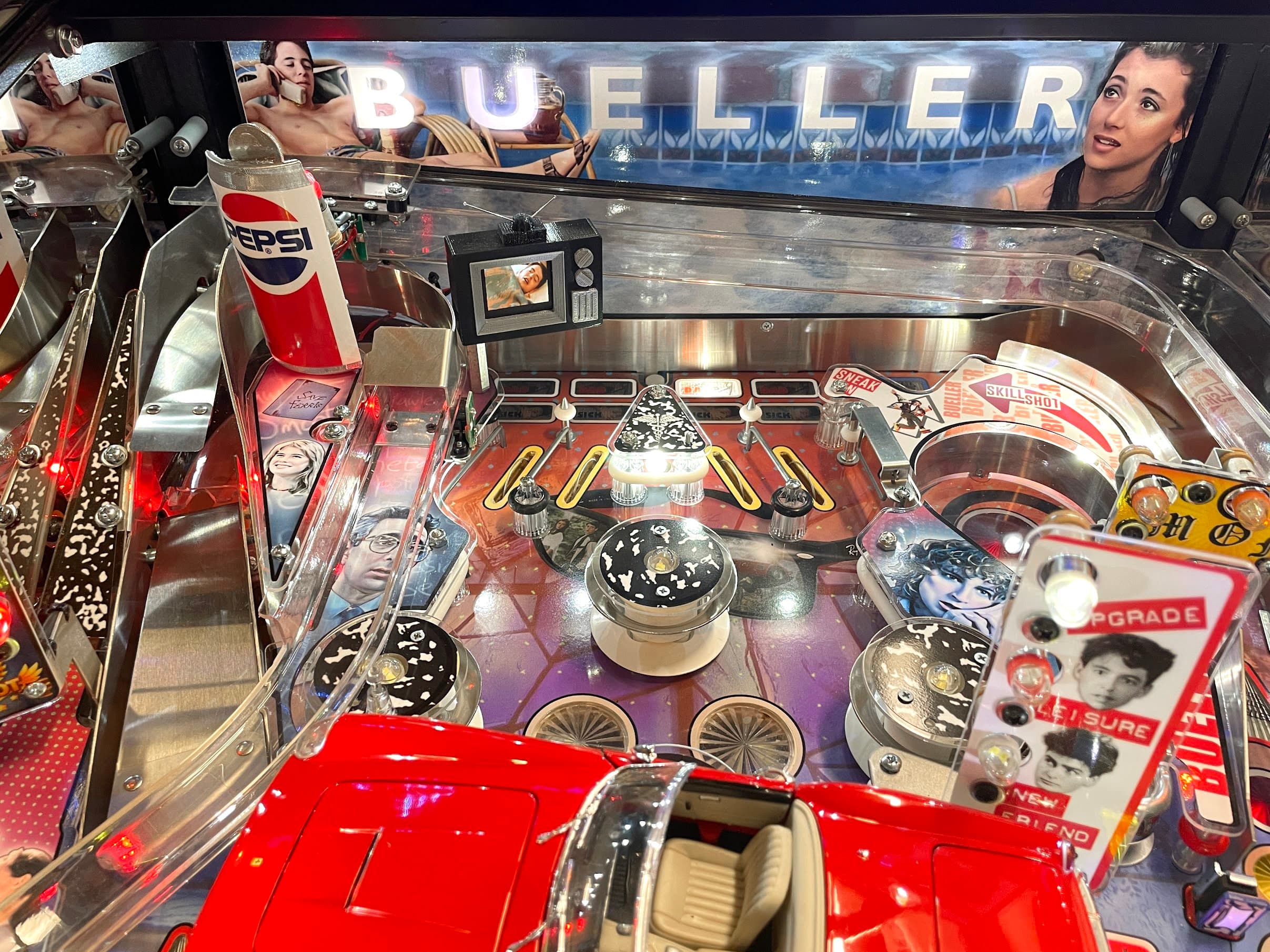 Detailed pinball machine with Pepsi can, retro TV, and colorful playfield