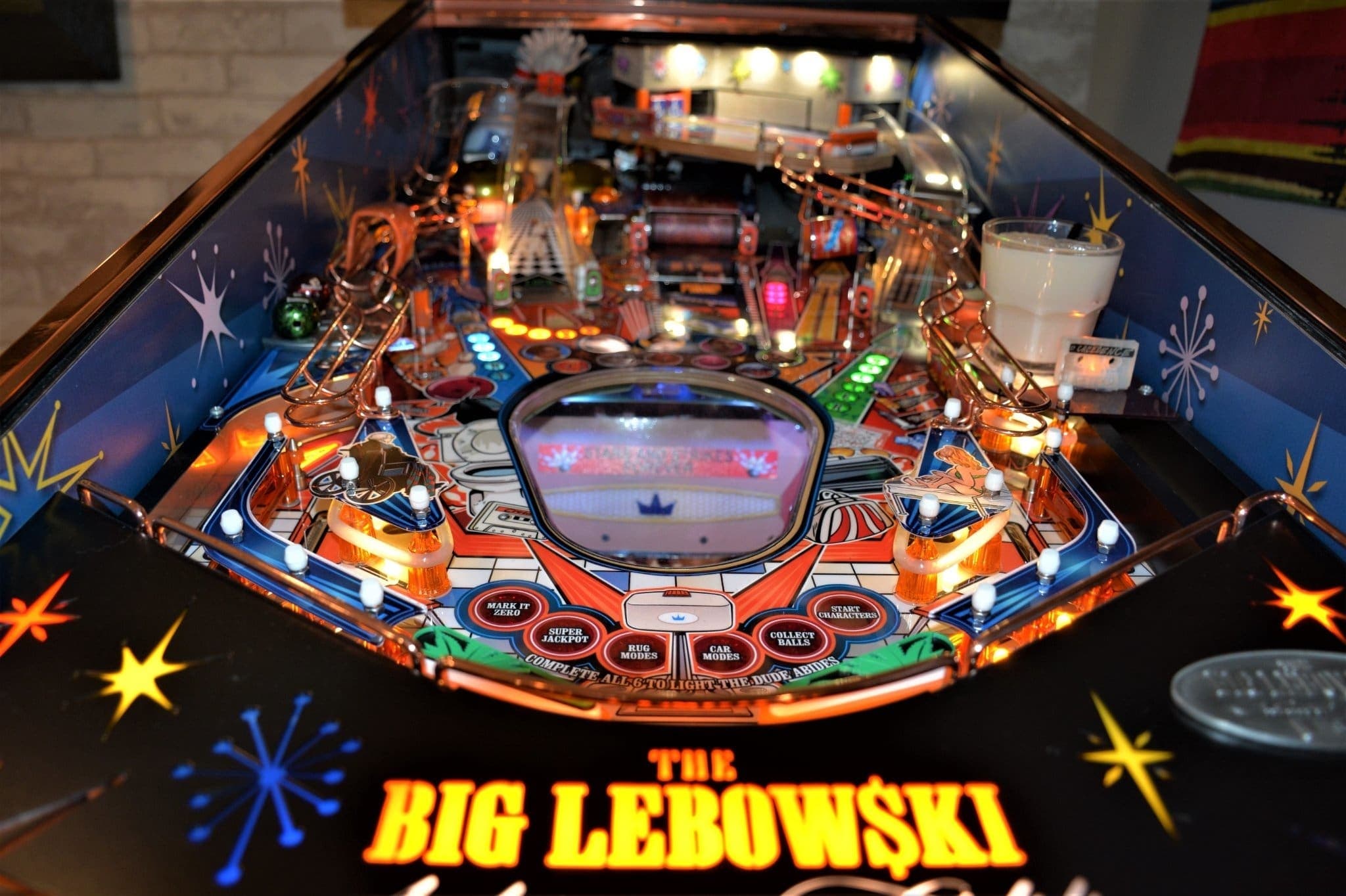 The Big Lebowski themed pinball machine with colorful lights and intricate design