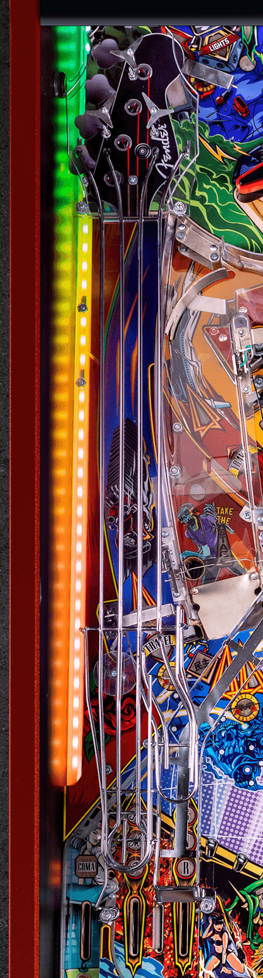 Colorful pinball machine detail with Fender guitar neck and vibrant graphics