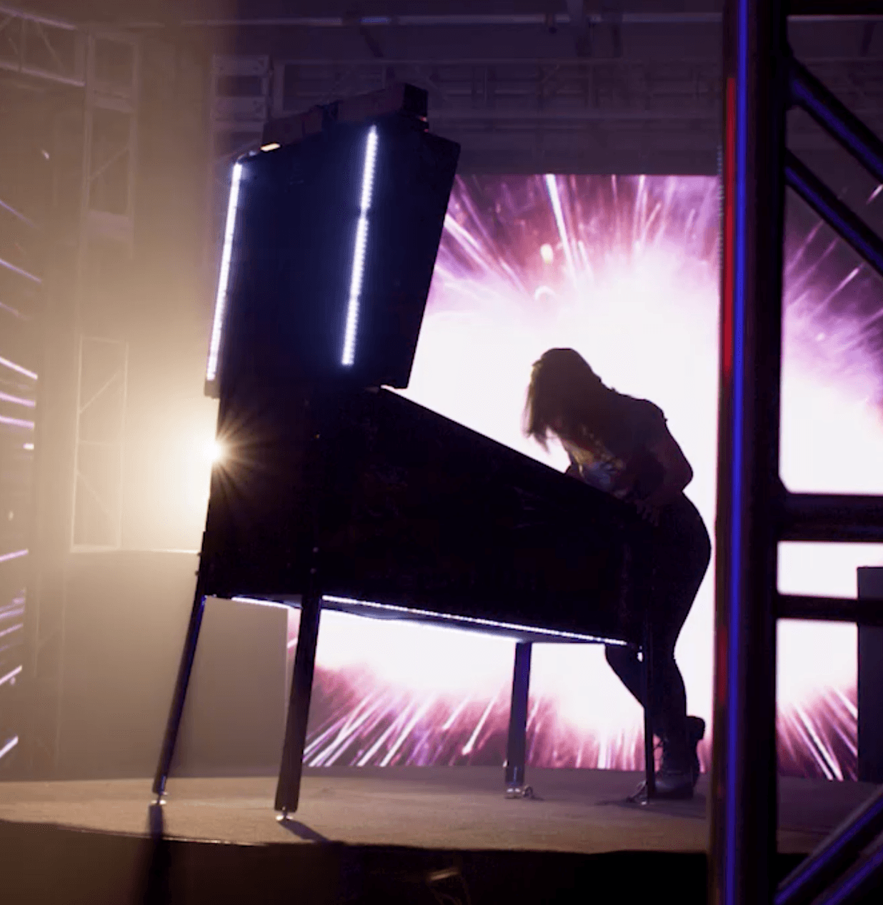 Silhouette of a musician playing grand piano with dramatic stage lighting