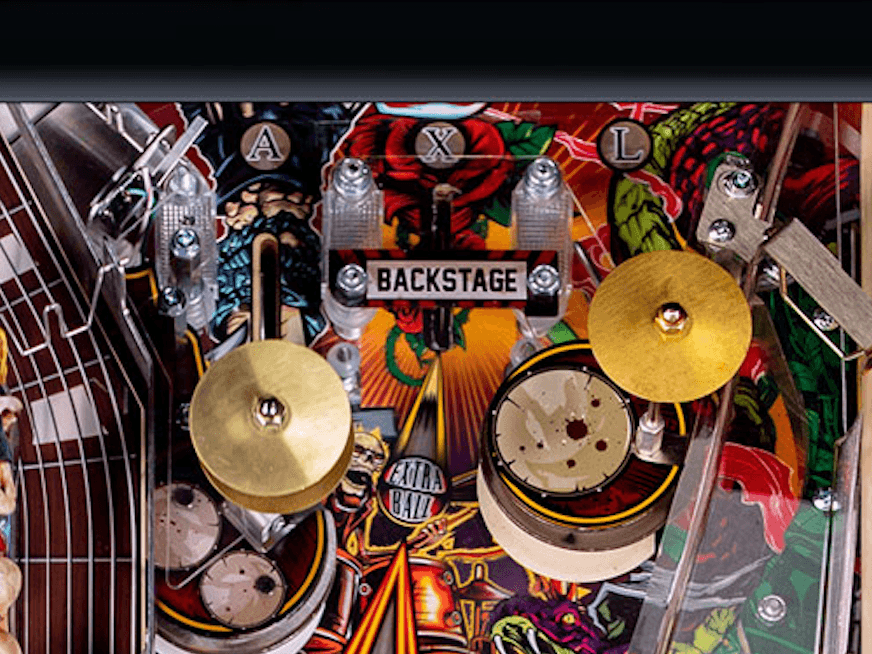 Pinball machine backstage view with colorful artwork and golden cymbals
