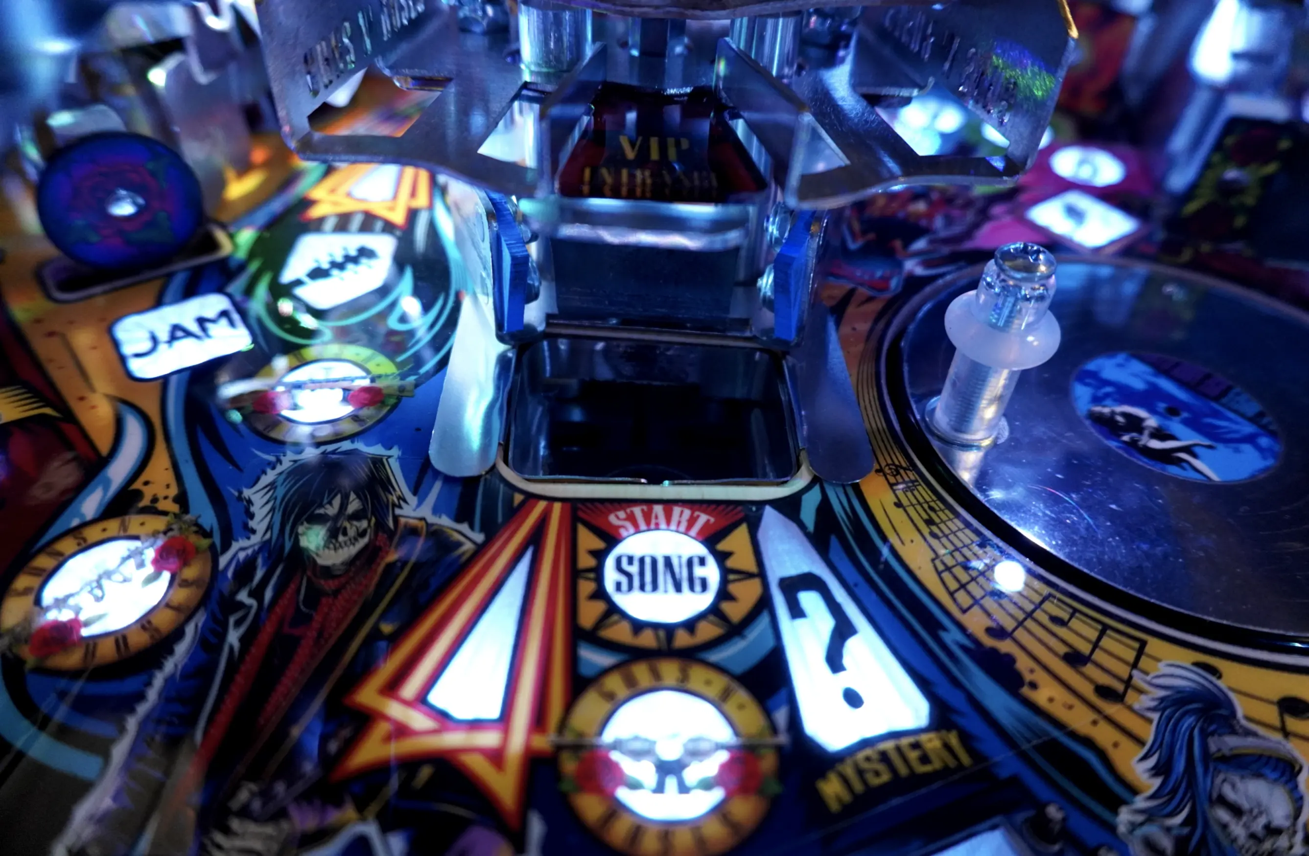 Close-up of colorful pinball machine with illuminated buttons and cartoon characters