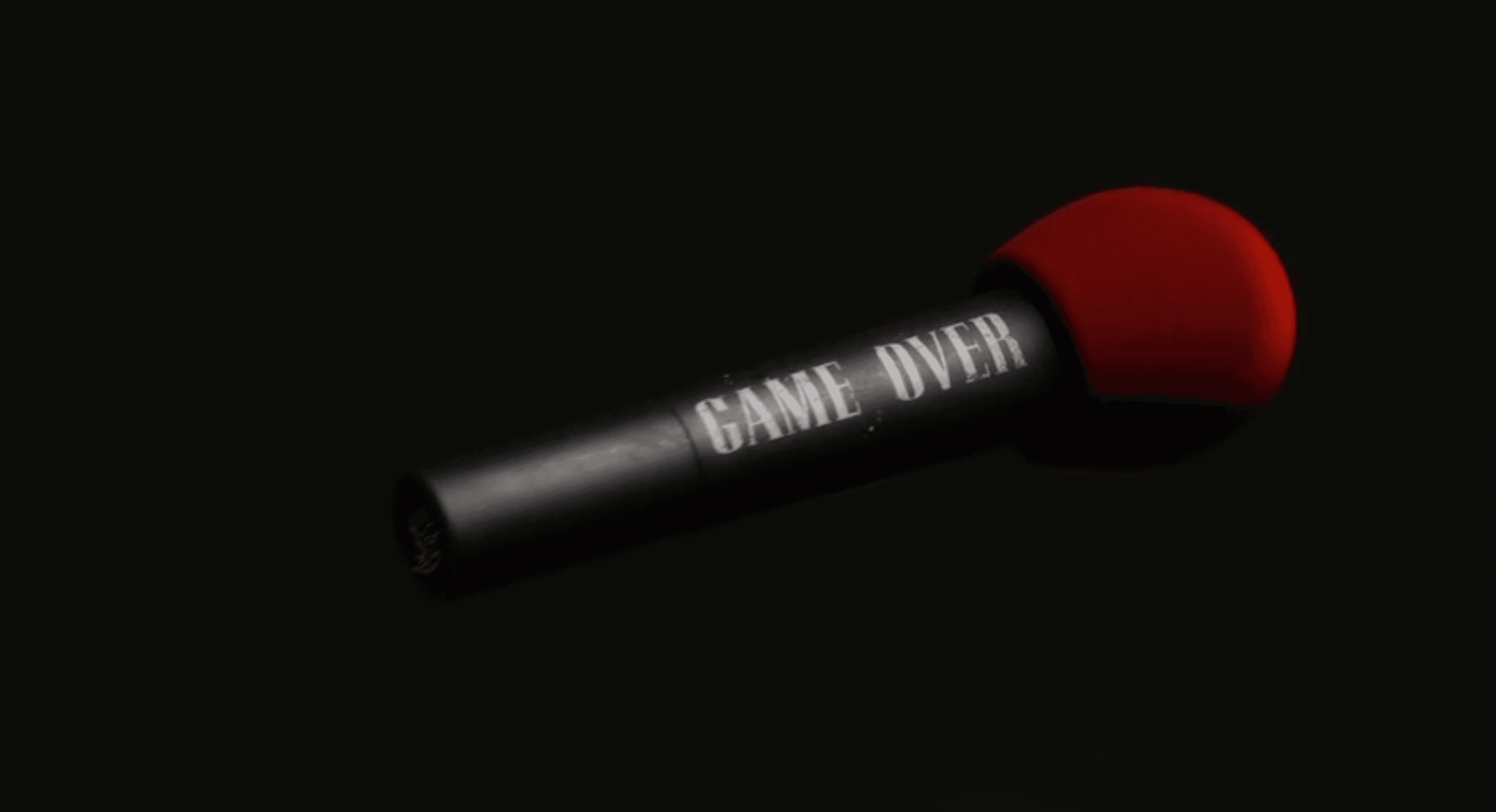 Microphone with "Game Over" text against dark background