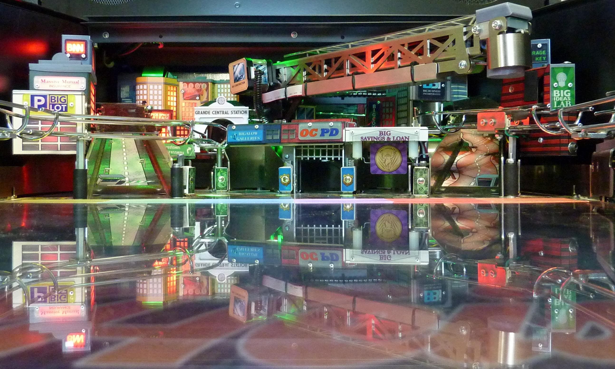 Miniature city model with reflective surface, featuring urban buildings and infrastructure