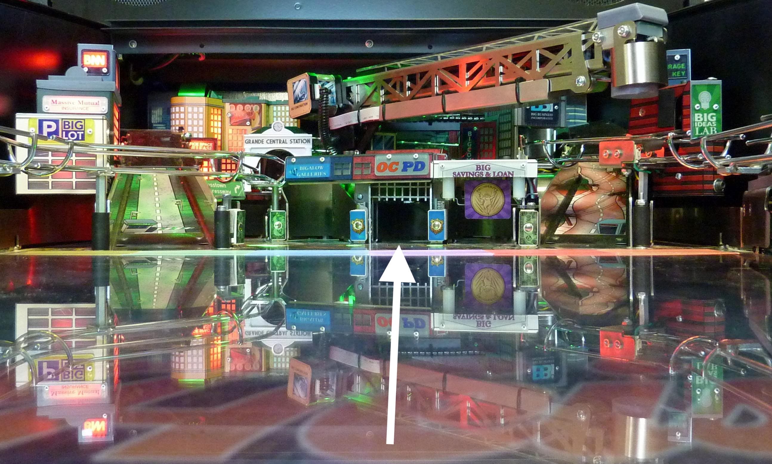 Miniature city model with reflective surface, featuring urban buildings and infrastructure