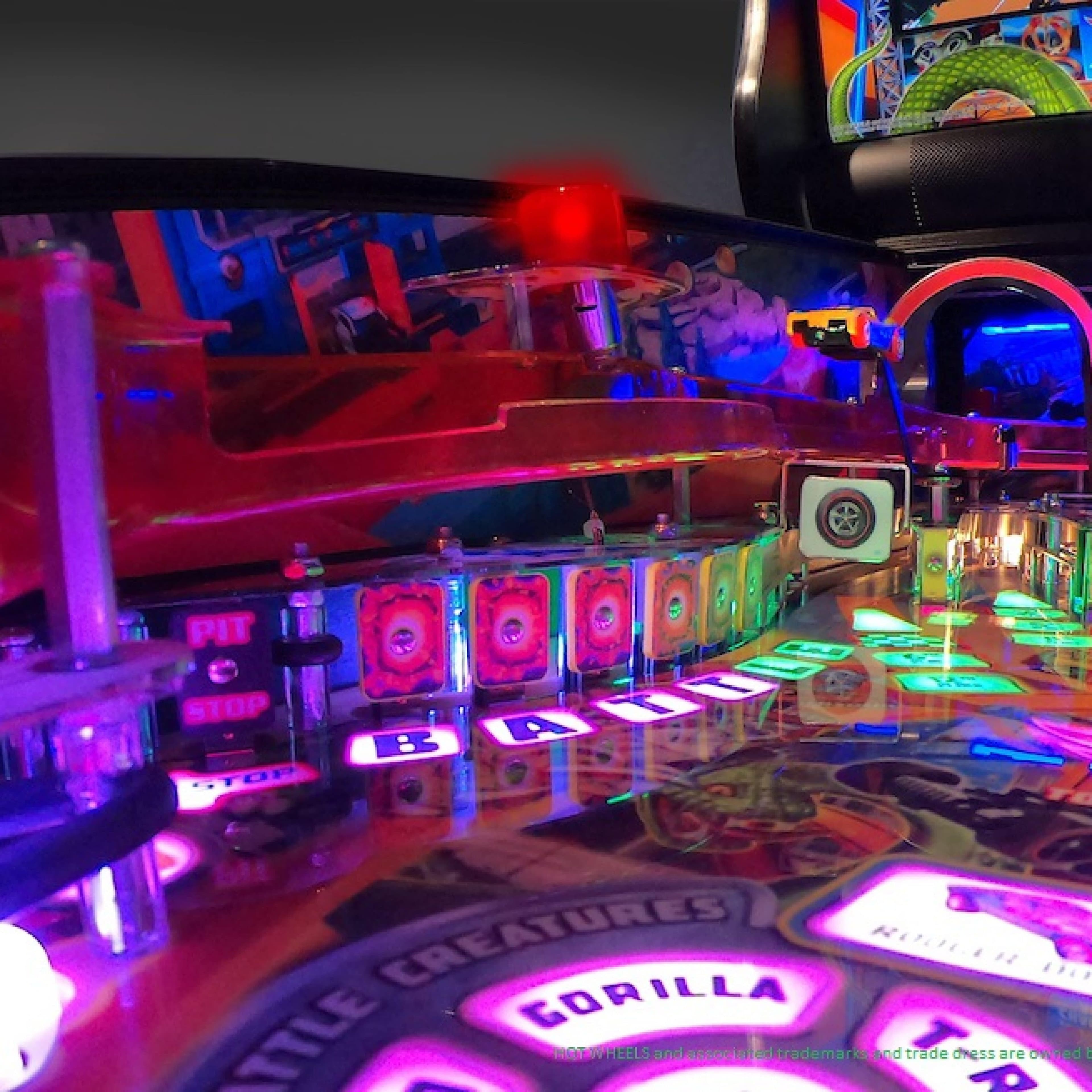 Colorful pinball machine with vibrant lights and neon-lit game elements