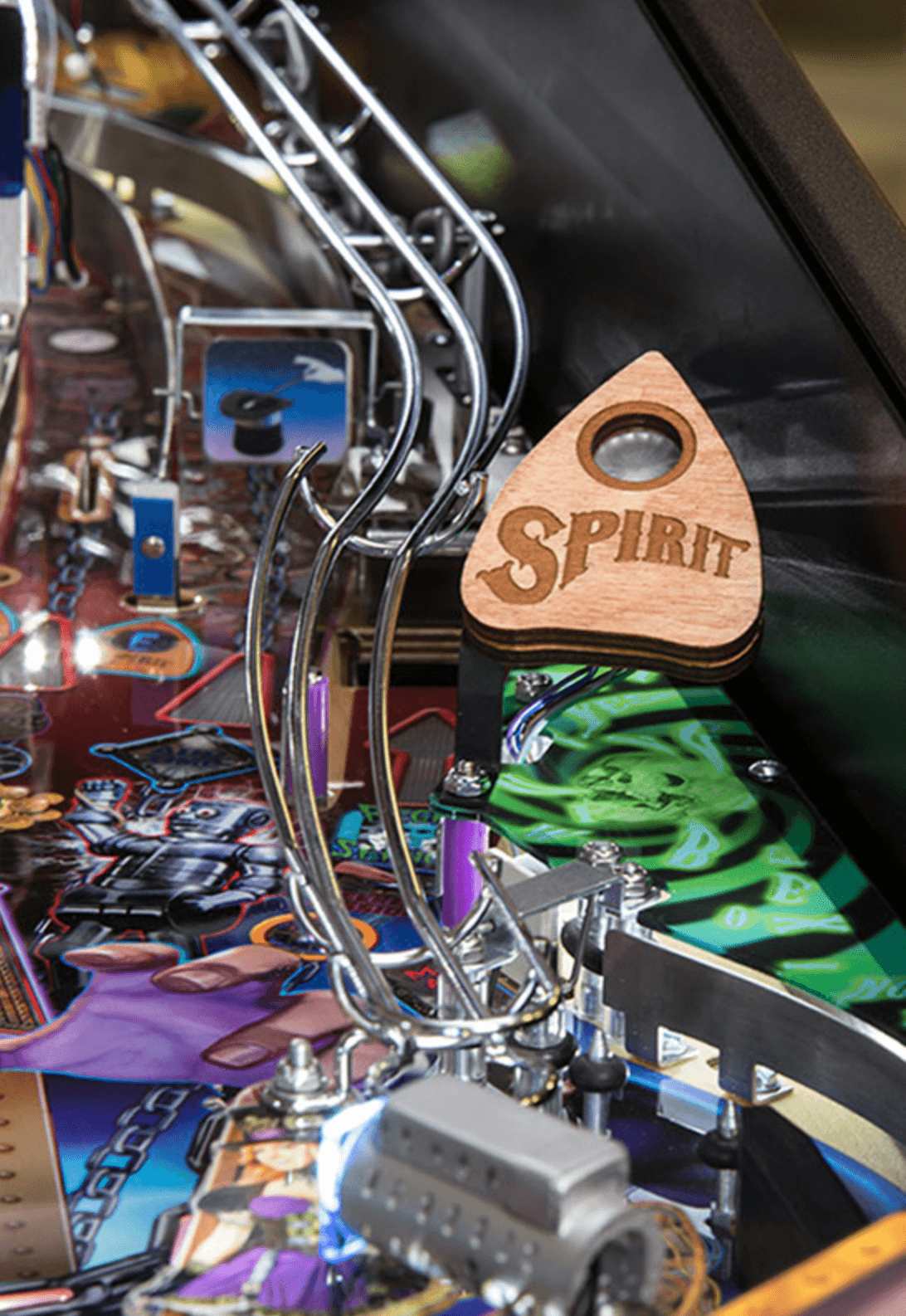 Wooden Spirit planchette on a colorful pinball machine playfield