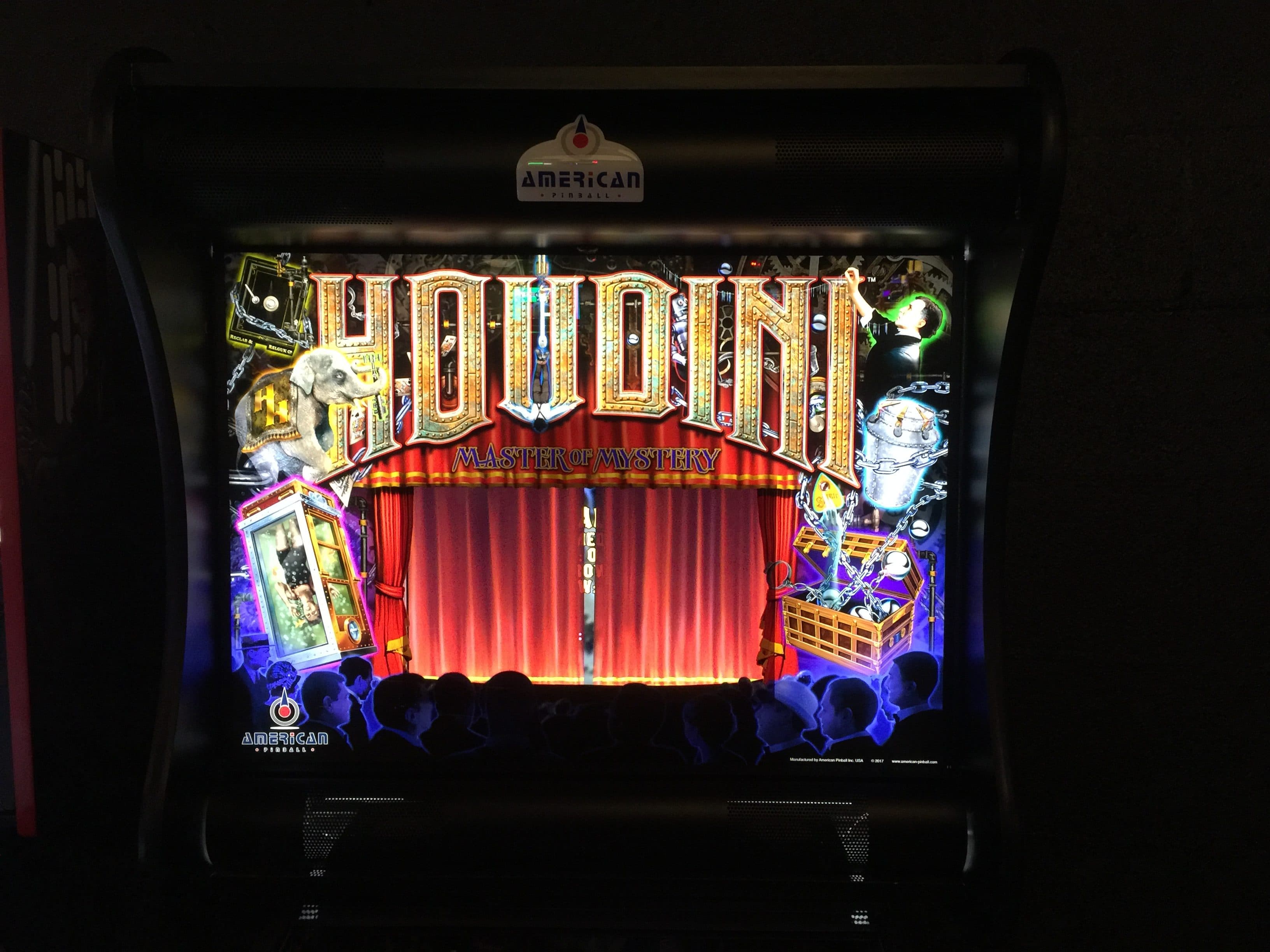 Houdini pinball machine with red curtain and magical themed artwork