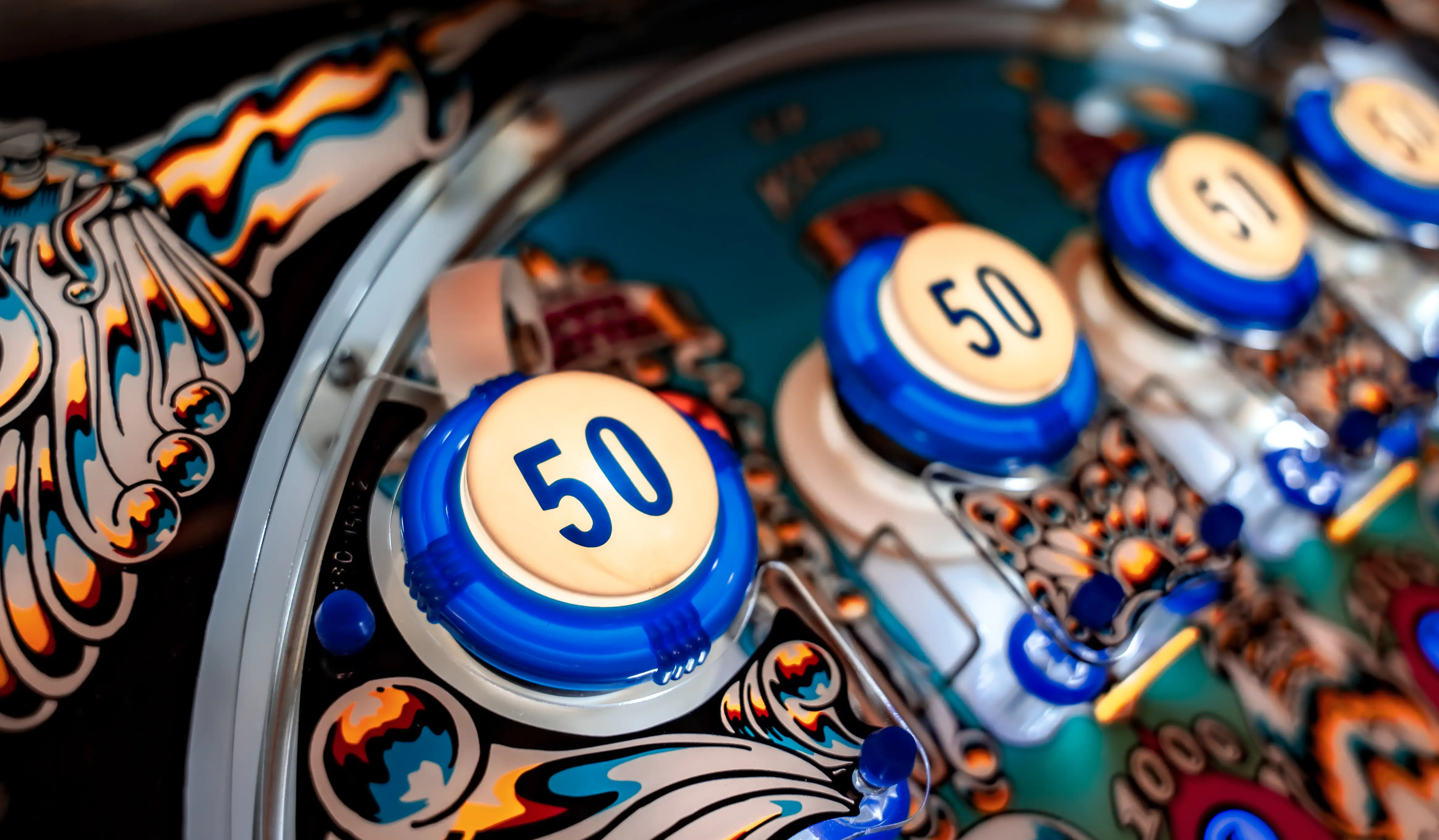 Blue and white bingo balls with number 50 on a colorful game board