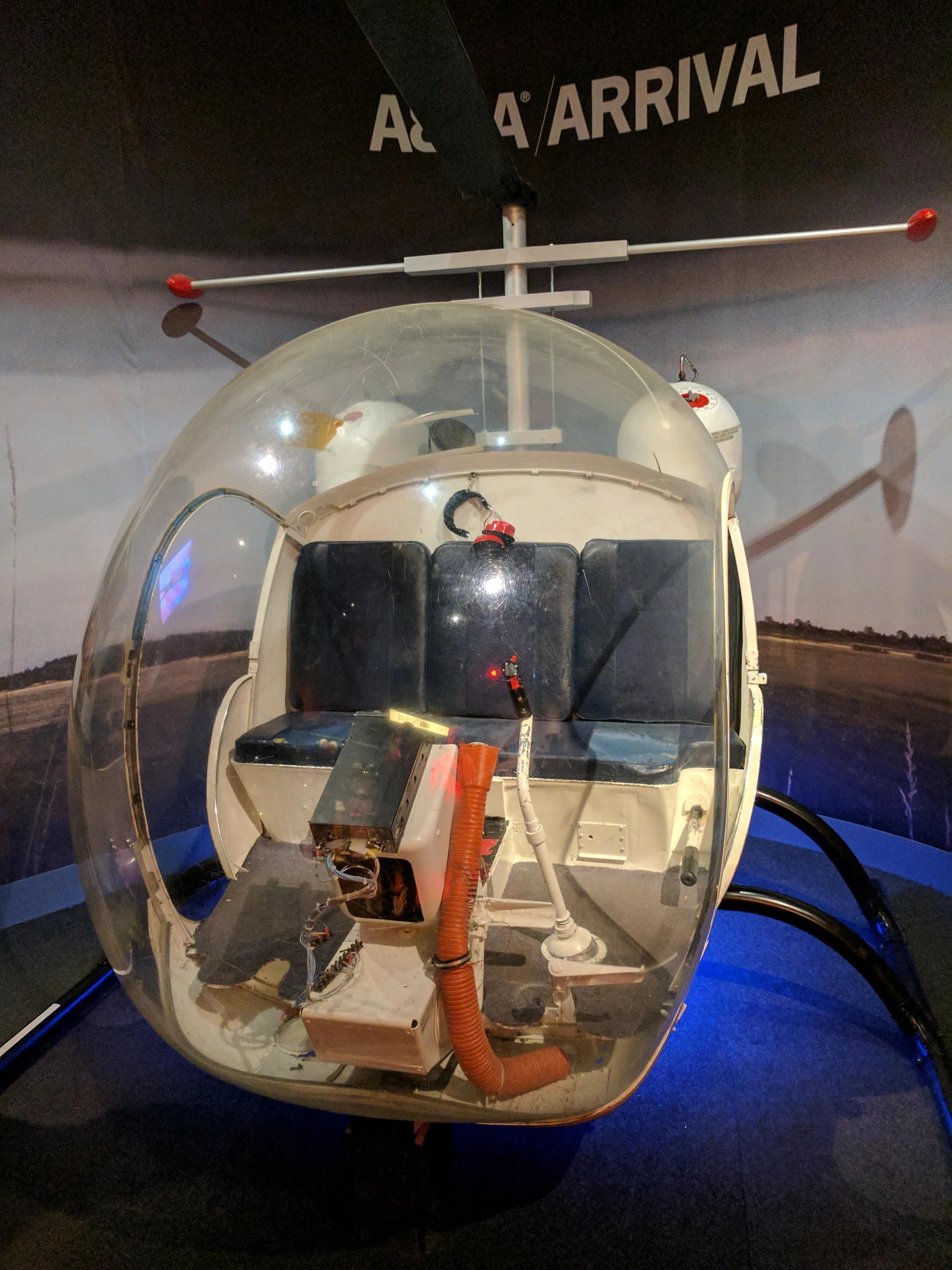 Transparent spherical helicopter cockpit on display at Arrival aviation exhibit
