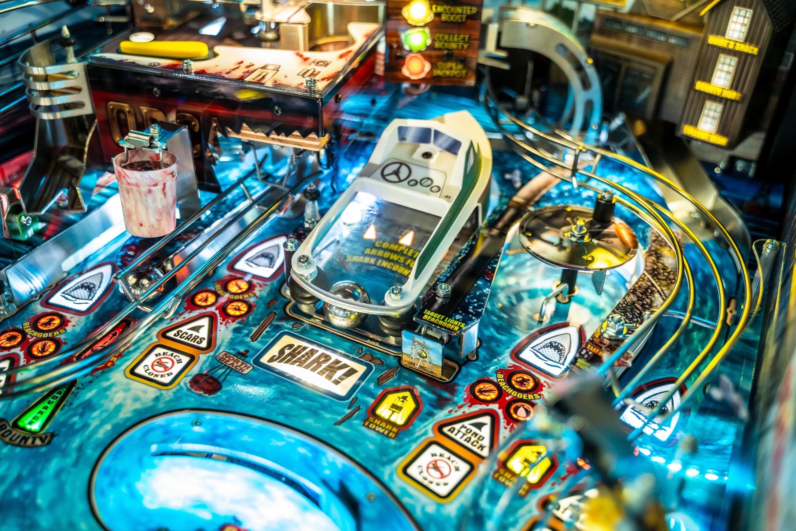 Detailed shark-themed pinball machine with blue surface and various game elements