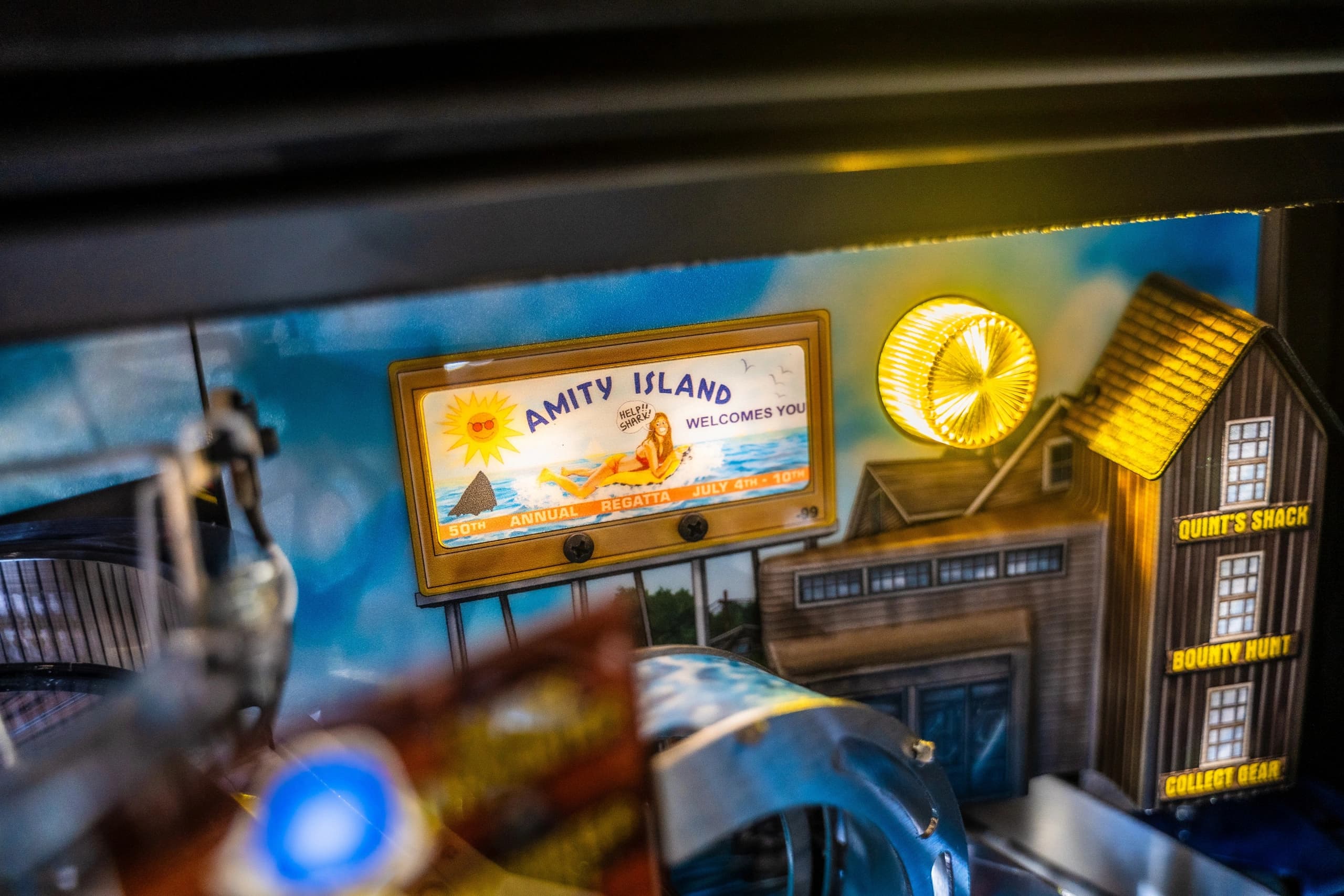 Amity Island welcome sign with beach scene and Quint's Shack in background