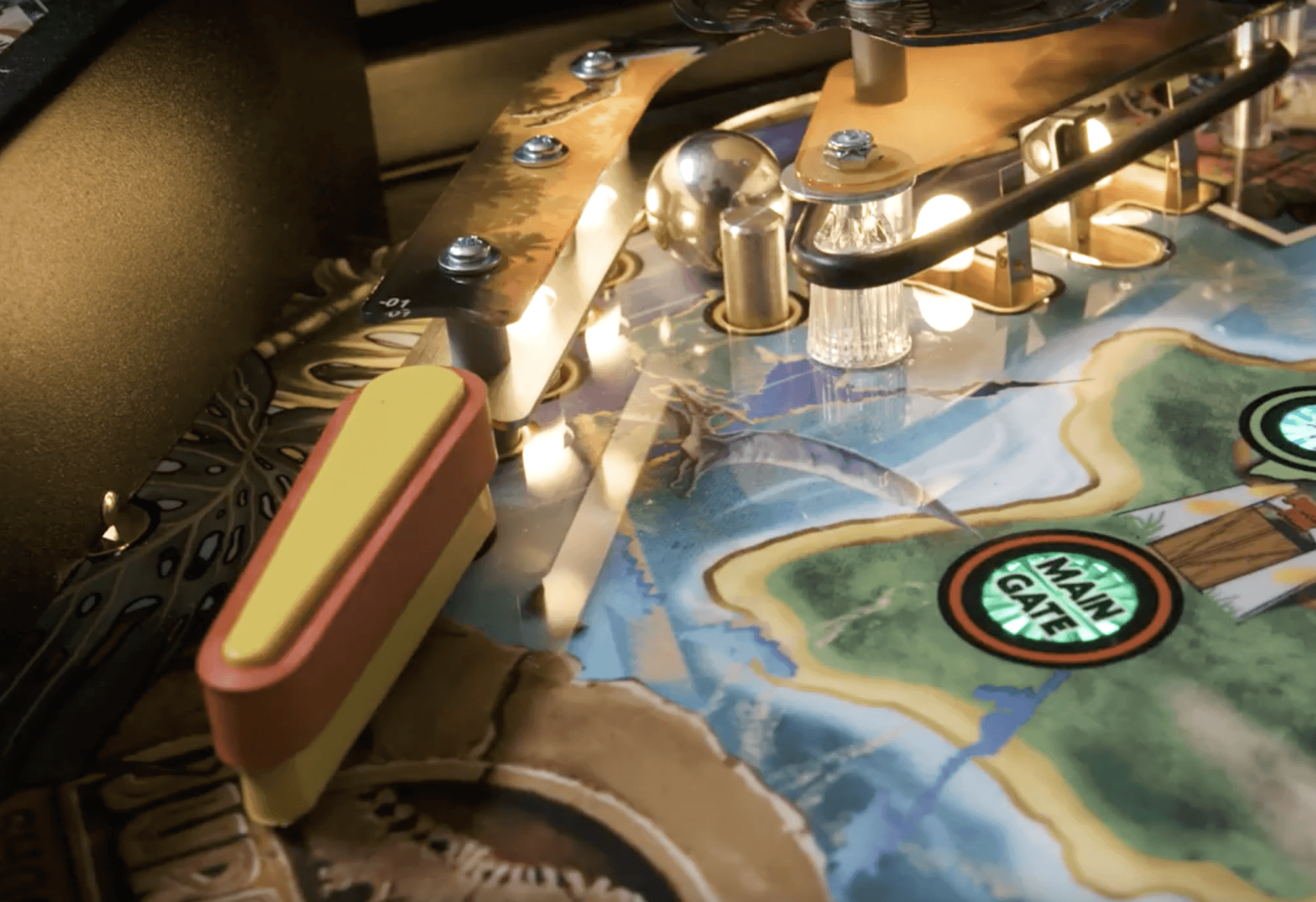 Pinball machine close-up with colorful playfield and illuminated game elements