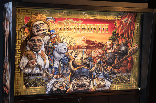 Colorful movie poster for Labyrinth with fantastical creatures and magical landscape