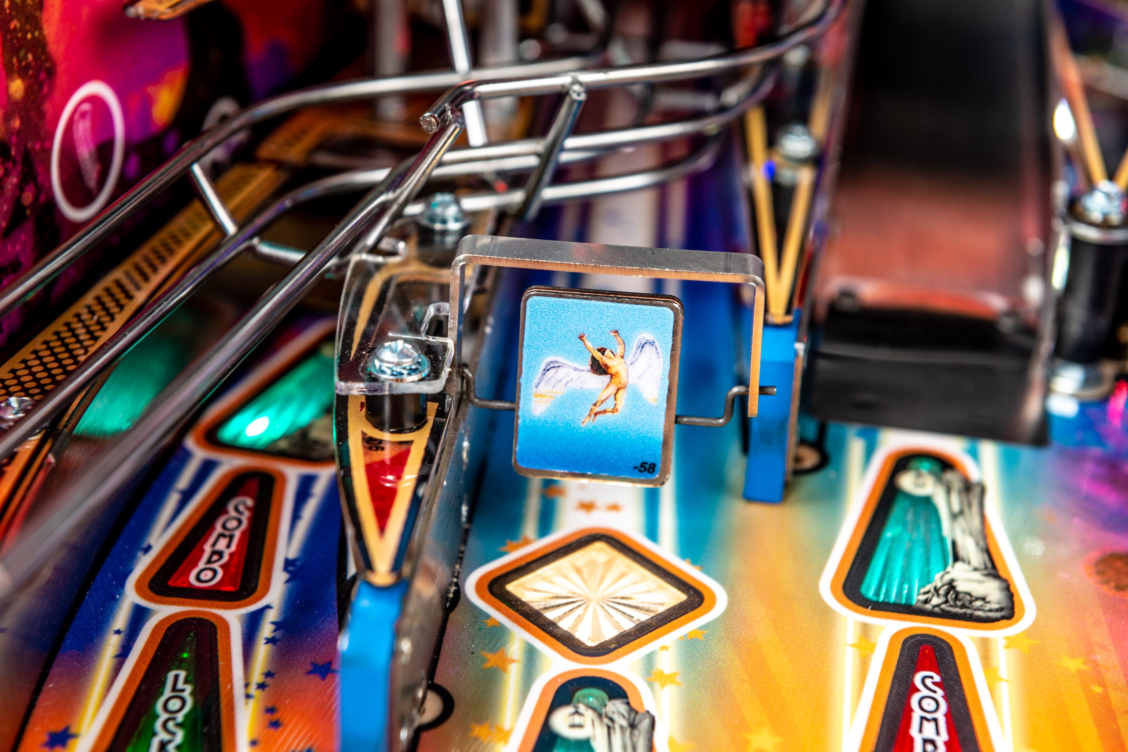 Colorful pinball machine with metallic parts and detailed graphic panels
