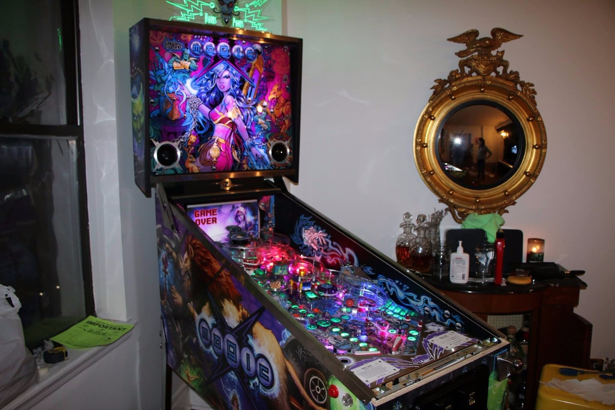 Colorful pinball machine with fantasy character artwork and illuminated playfield