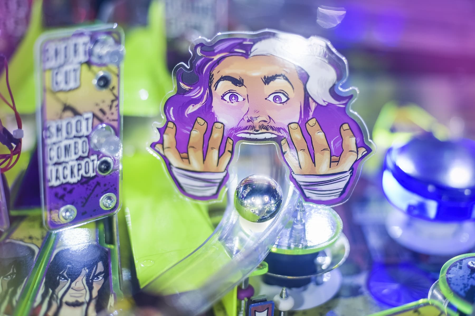 Pinball machine with cartoon character pressing hands against glass