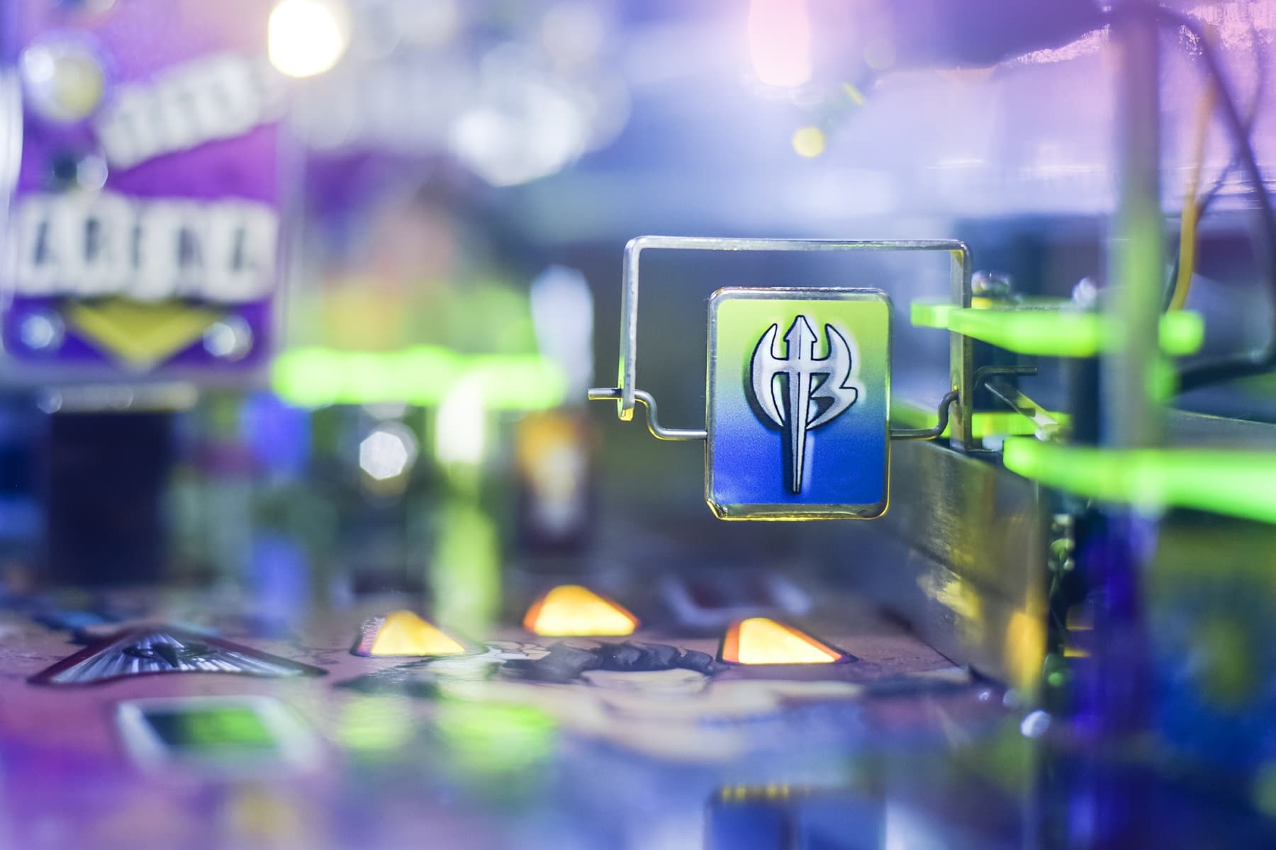 Blurred electronic circuit board with glowing blue and green elements