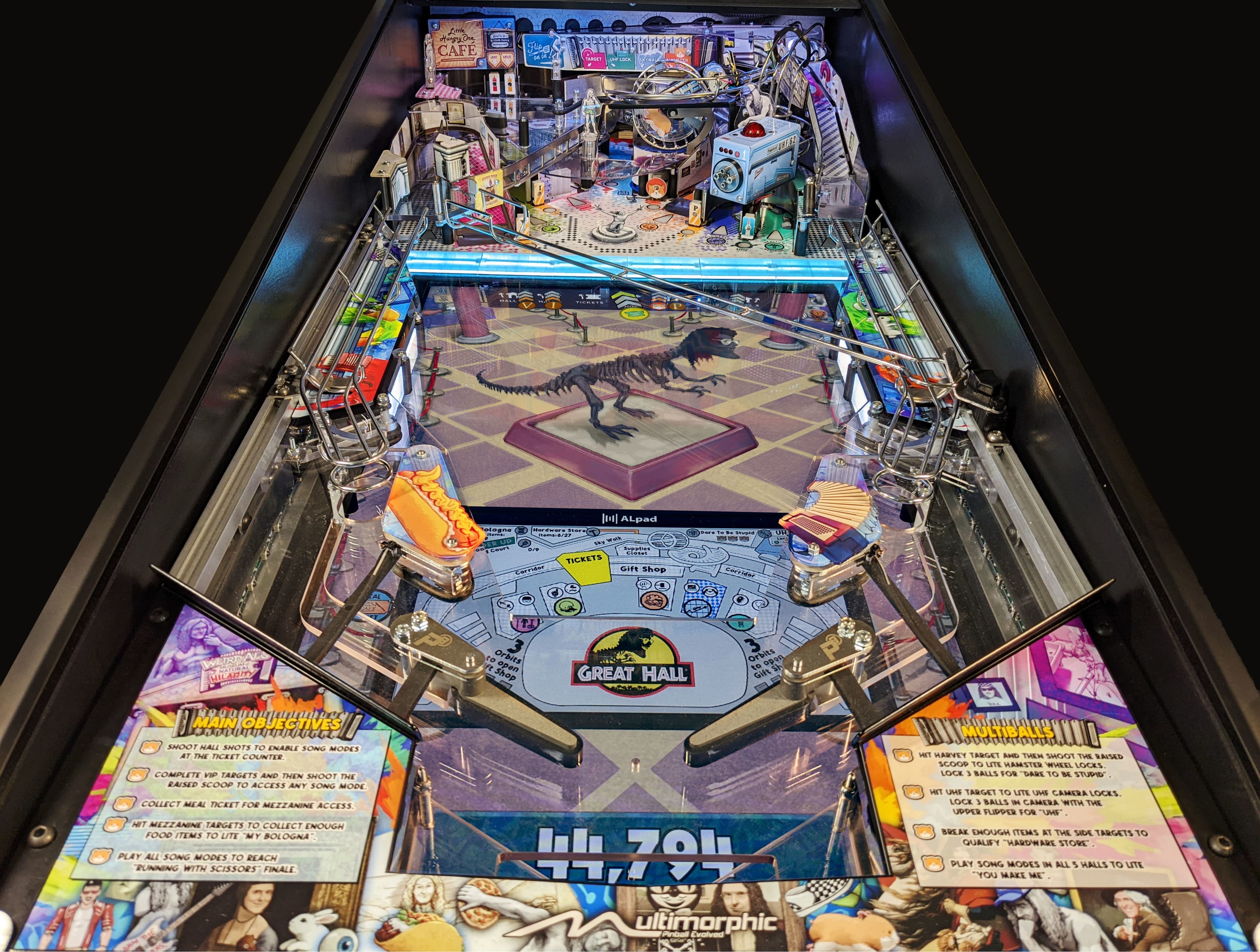Jurassic Park themed pinball machine with dinosaur skeleton on playfield