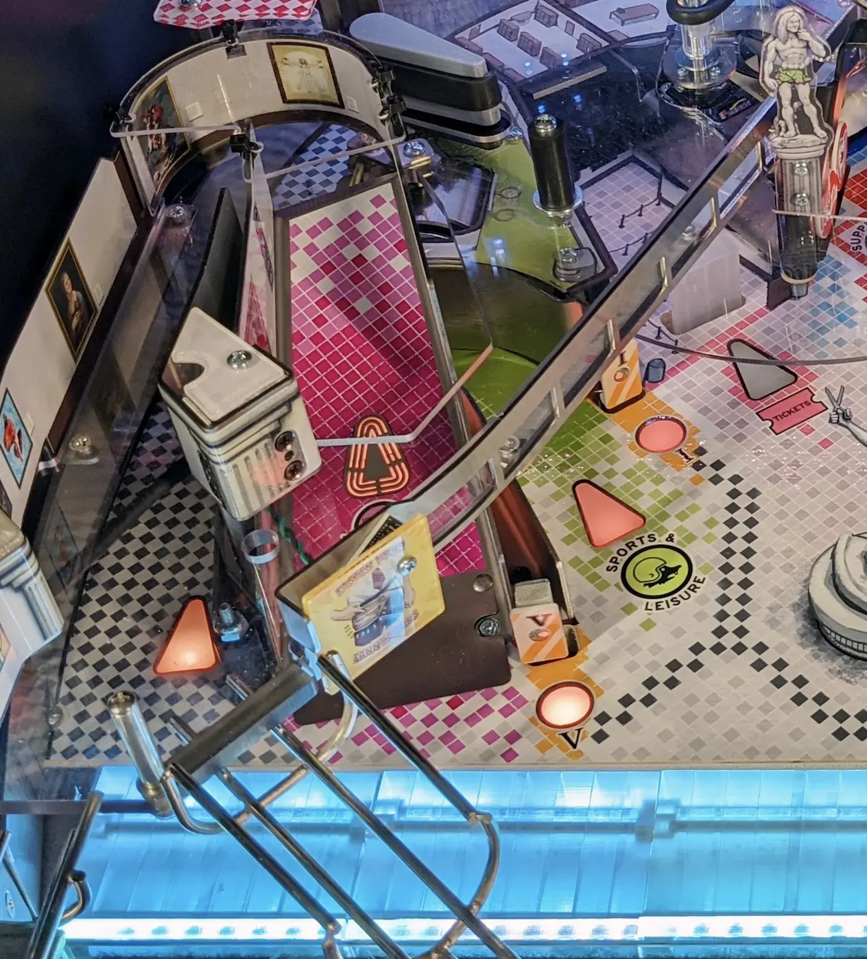 Pinball machine with colorful checkered playfield and Sports & Leisure logo