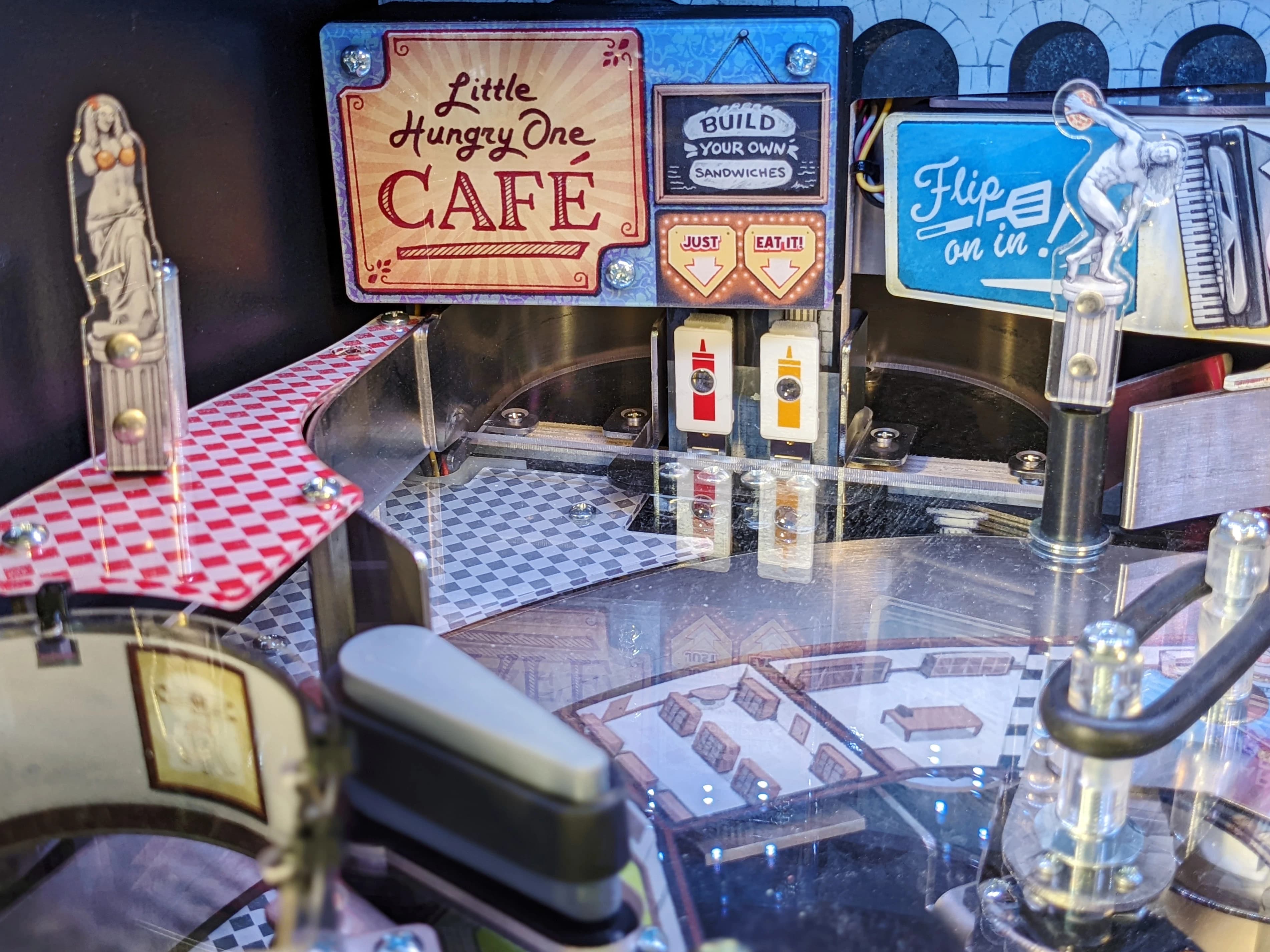 Miniature cafe setup with interactive sandwich-making station and playful signs