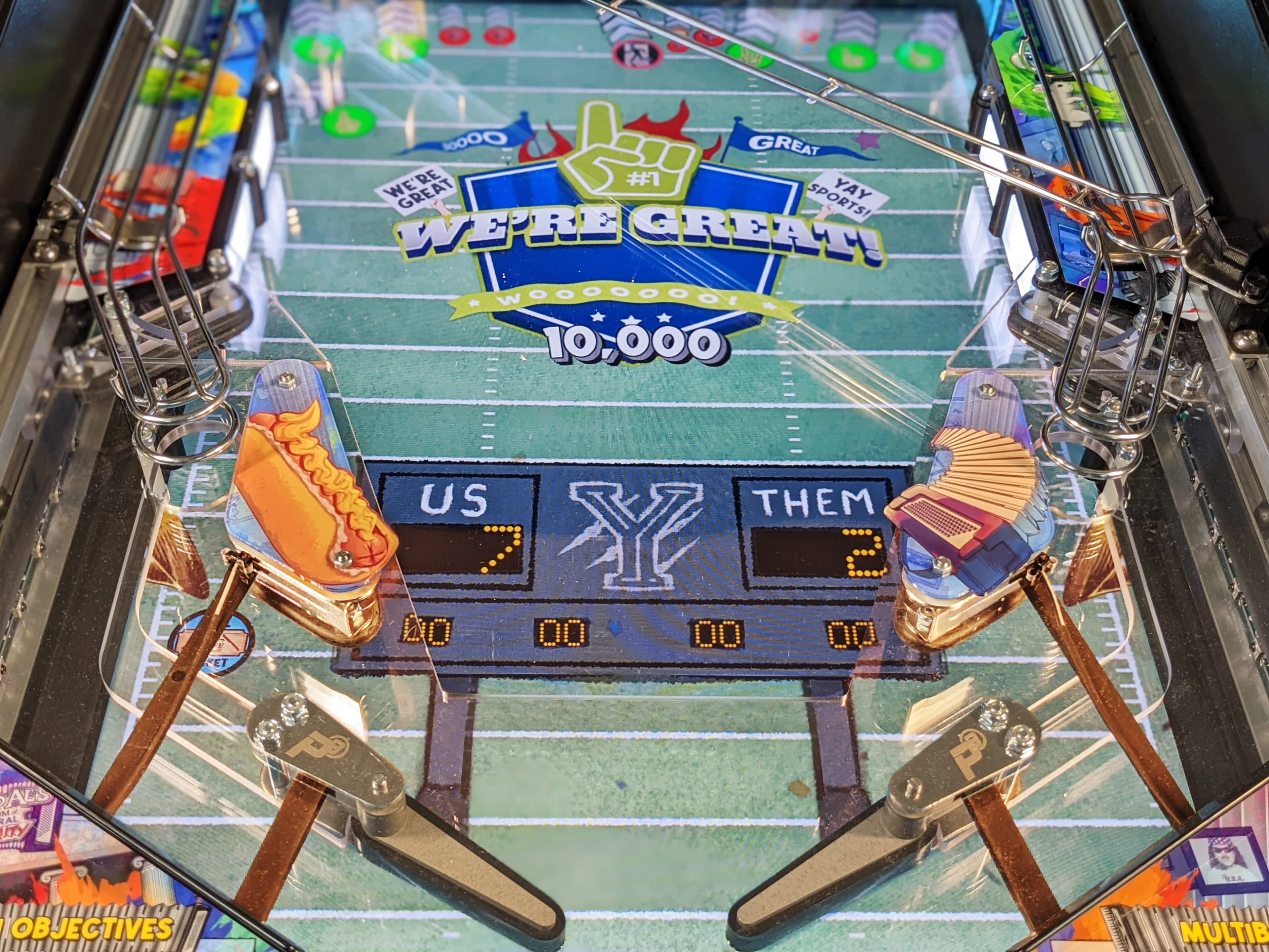 Football-themed pinball machine with scoreboard showing close game