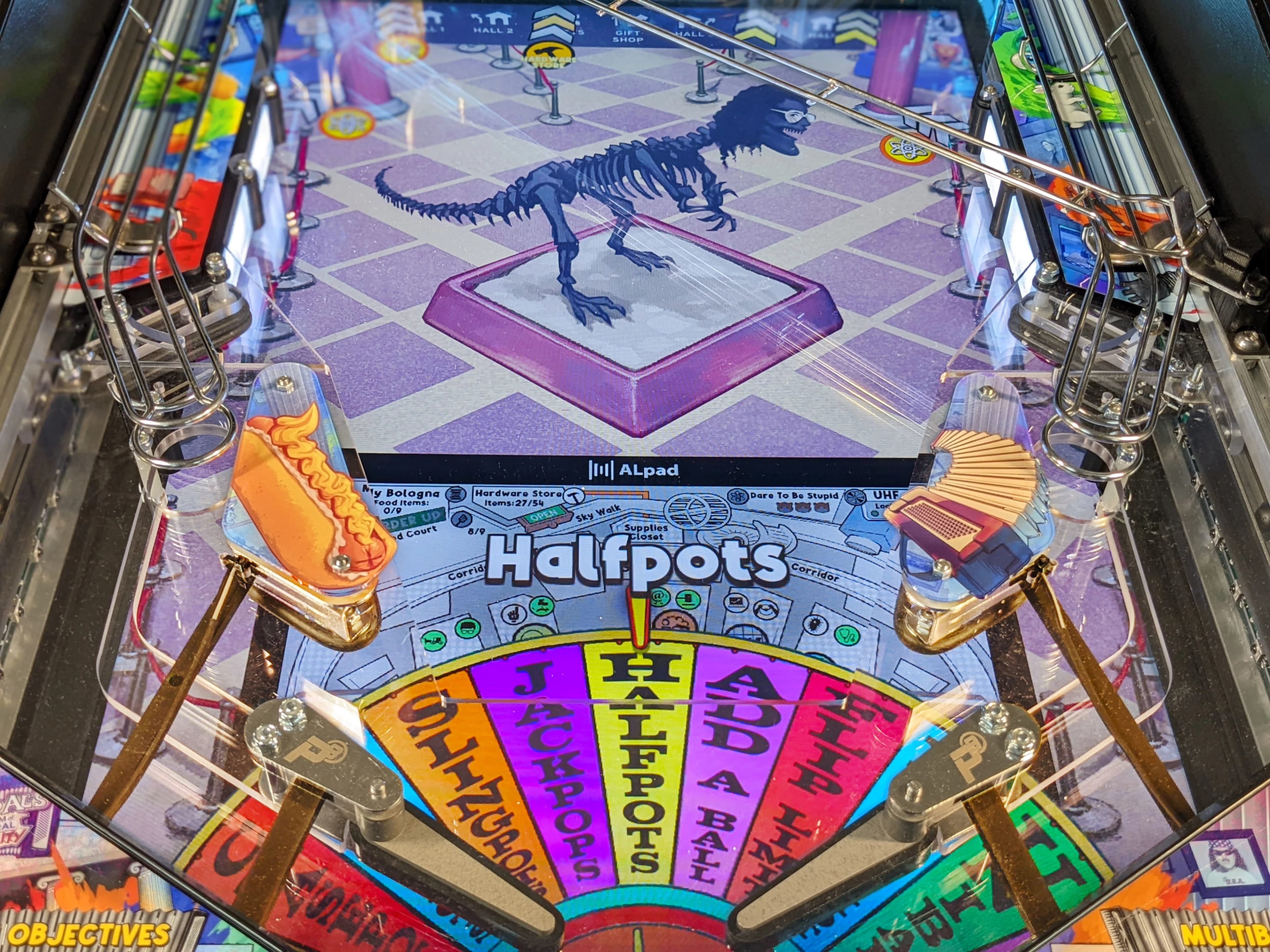 Halfpots pinball machine with colorful board and dinosaur skeleton display