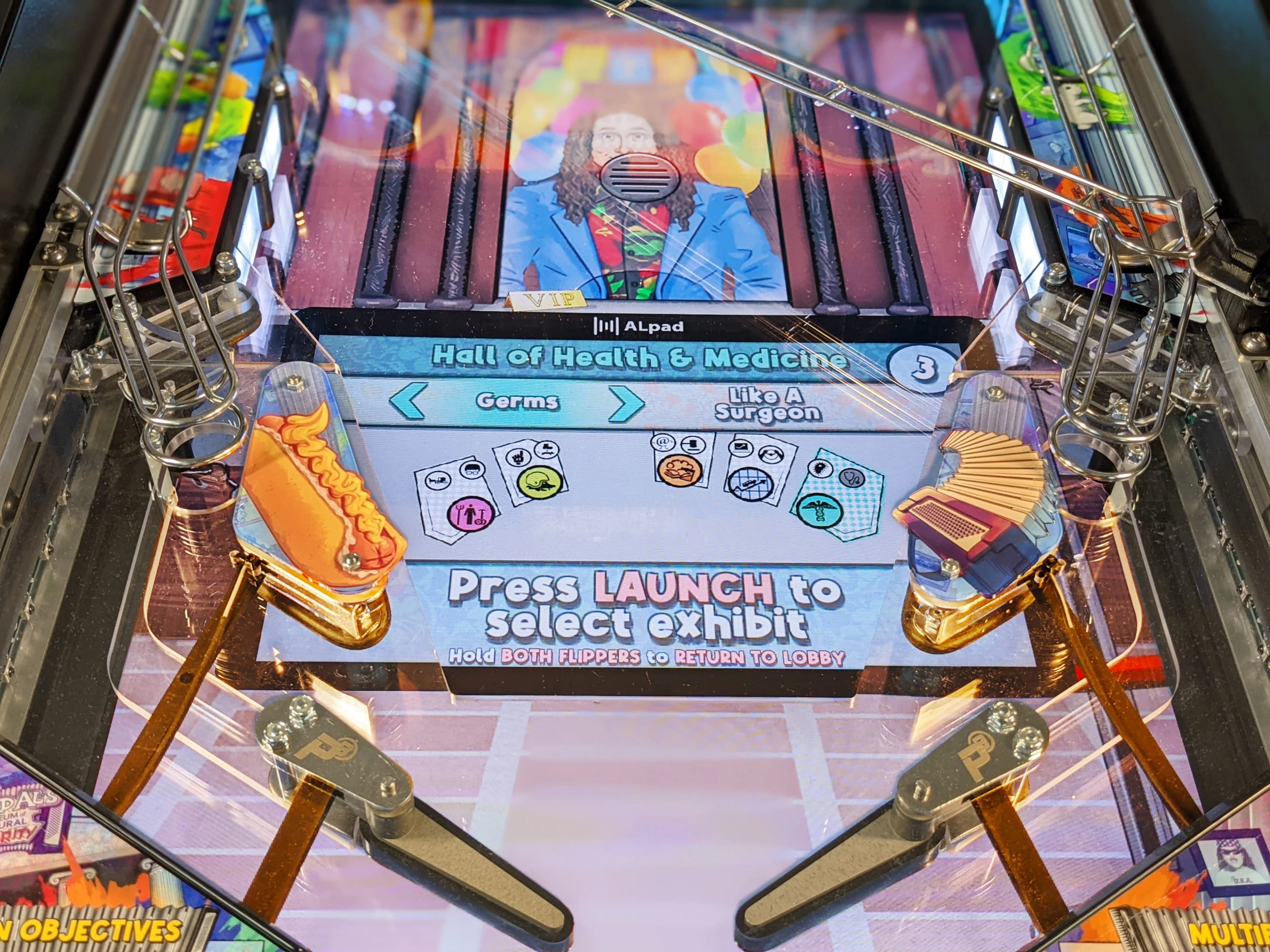 Pinball machine screen showing Hall of Health & Medicine exhibit selection