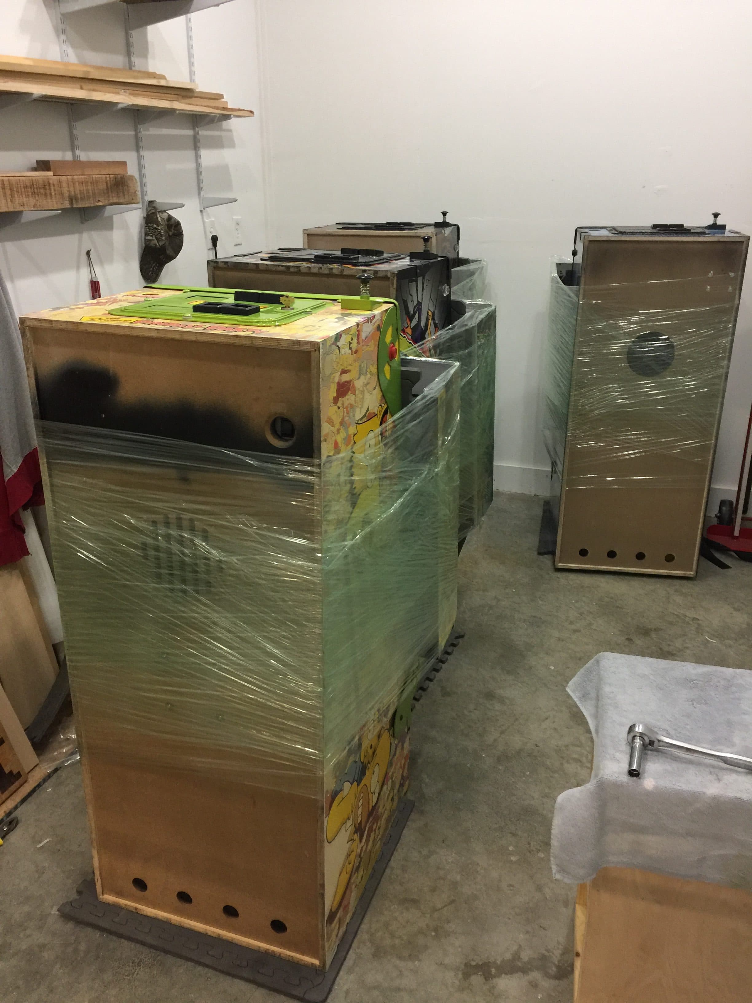 Wooden boxes wrapped in plastic in a workshop storage area