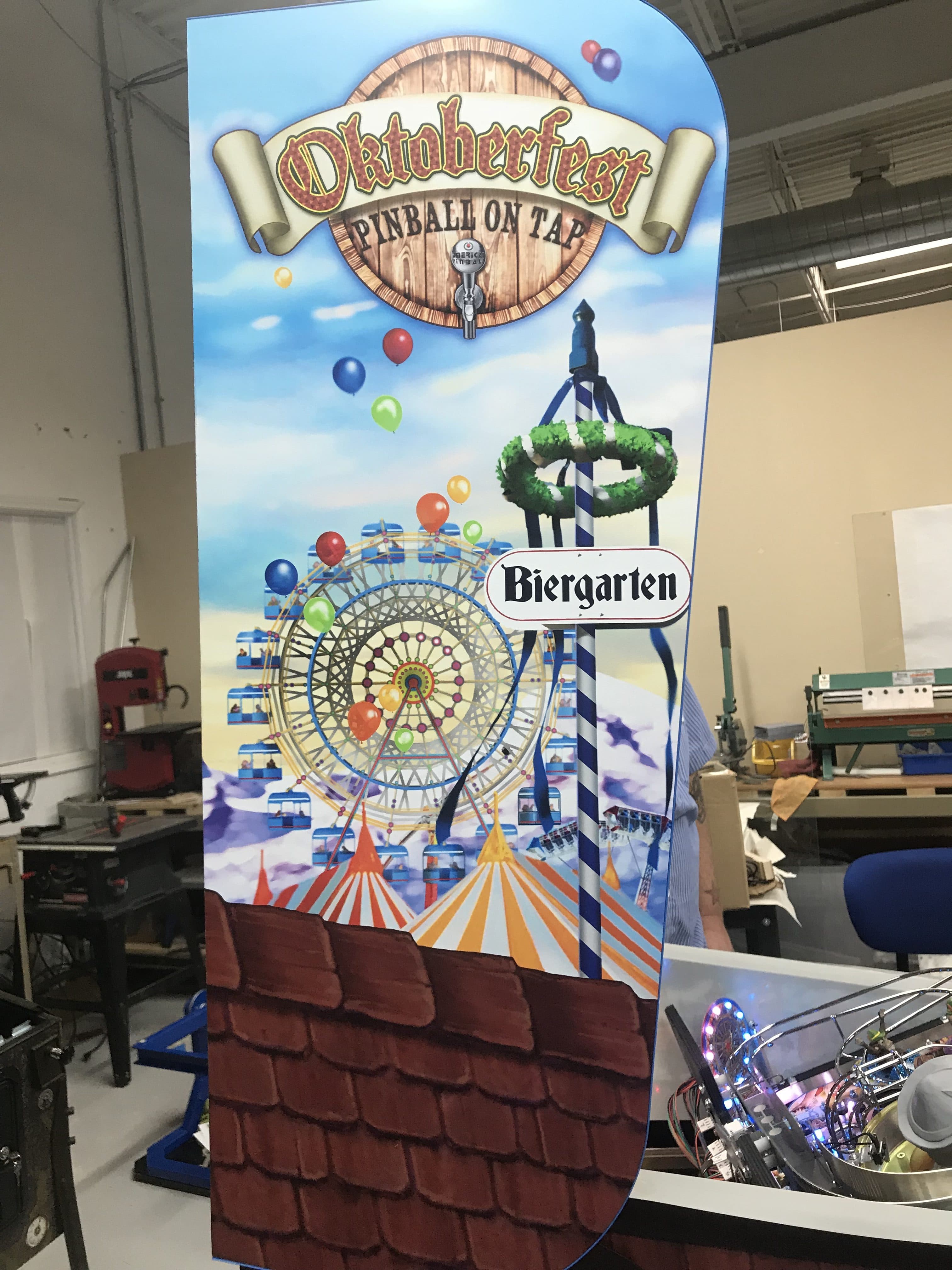 Oktoberfest pinball machine poster with ferris wheel and biergarten theme