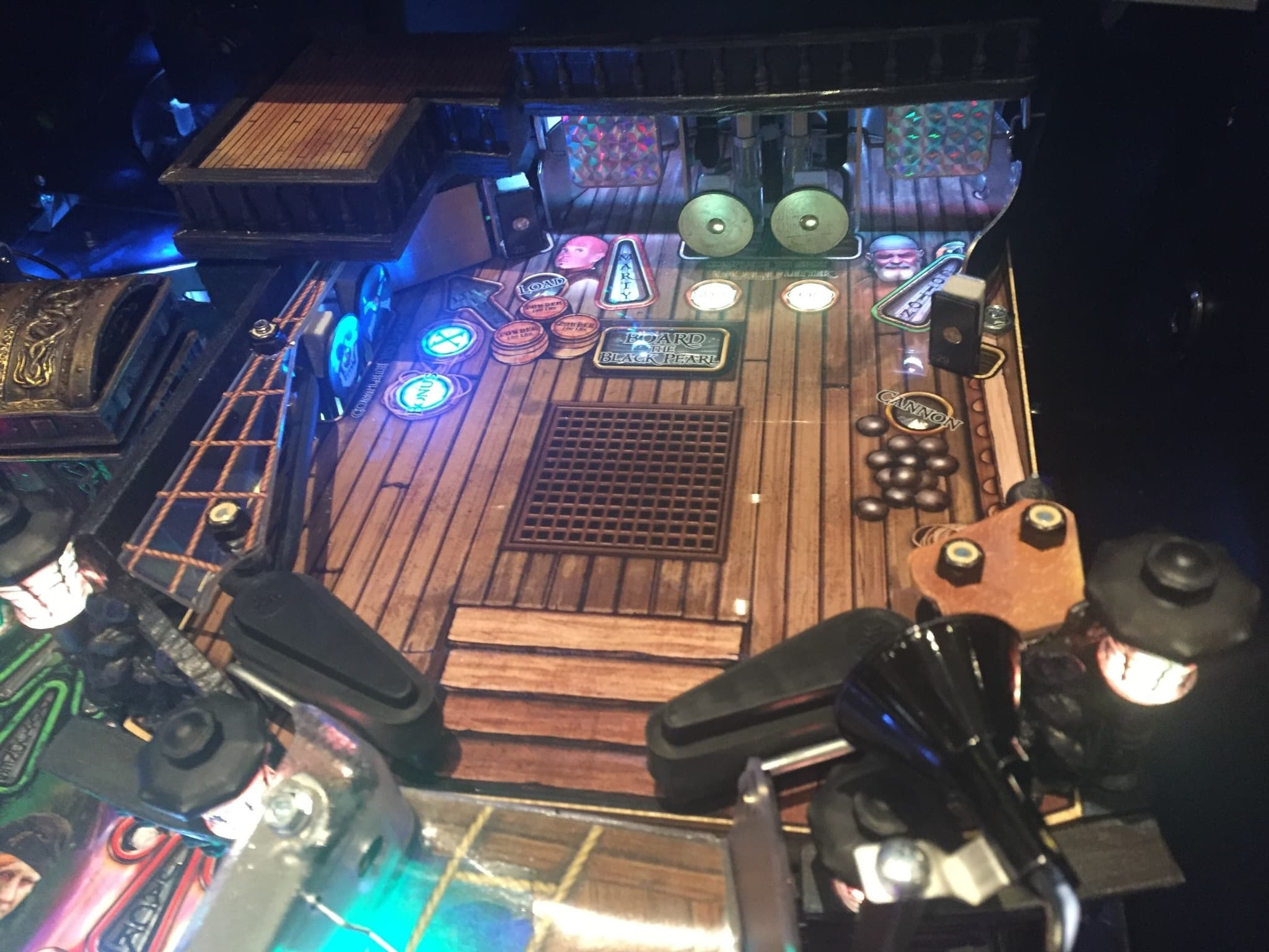 Illuminated board game with wooden deck and colorful game pieces