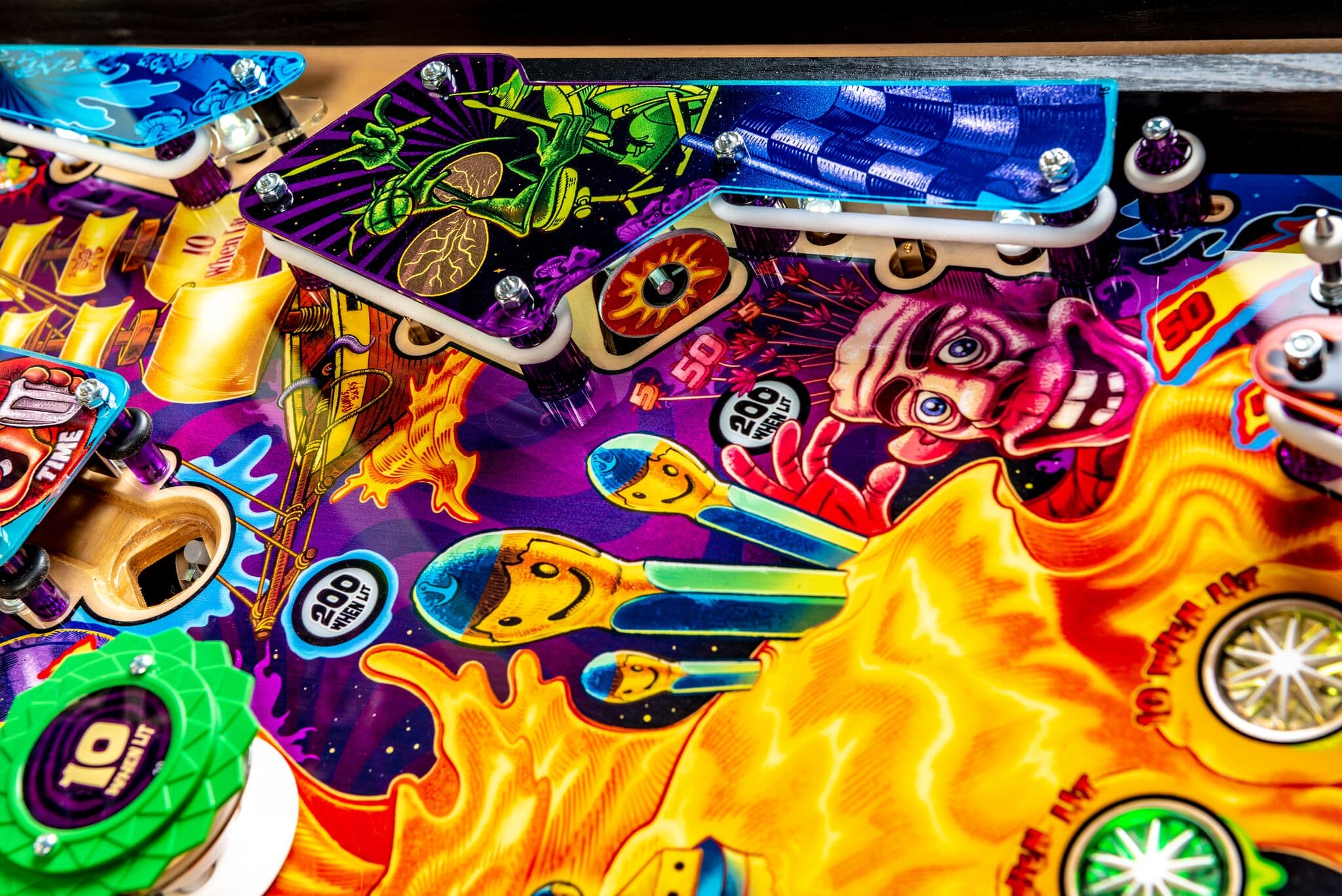 Colorful pinball machine playfield with vibrant cartoon-style graphics and characters