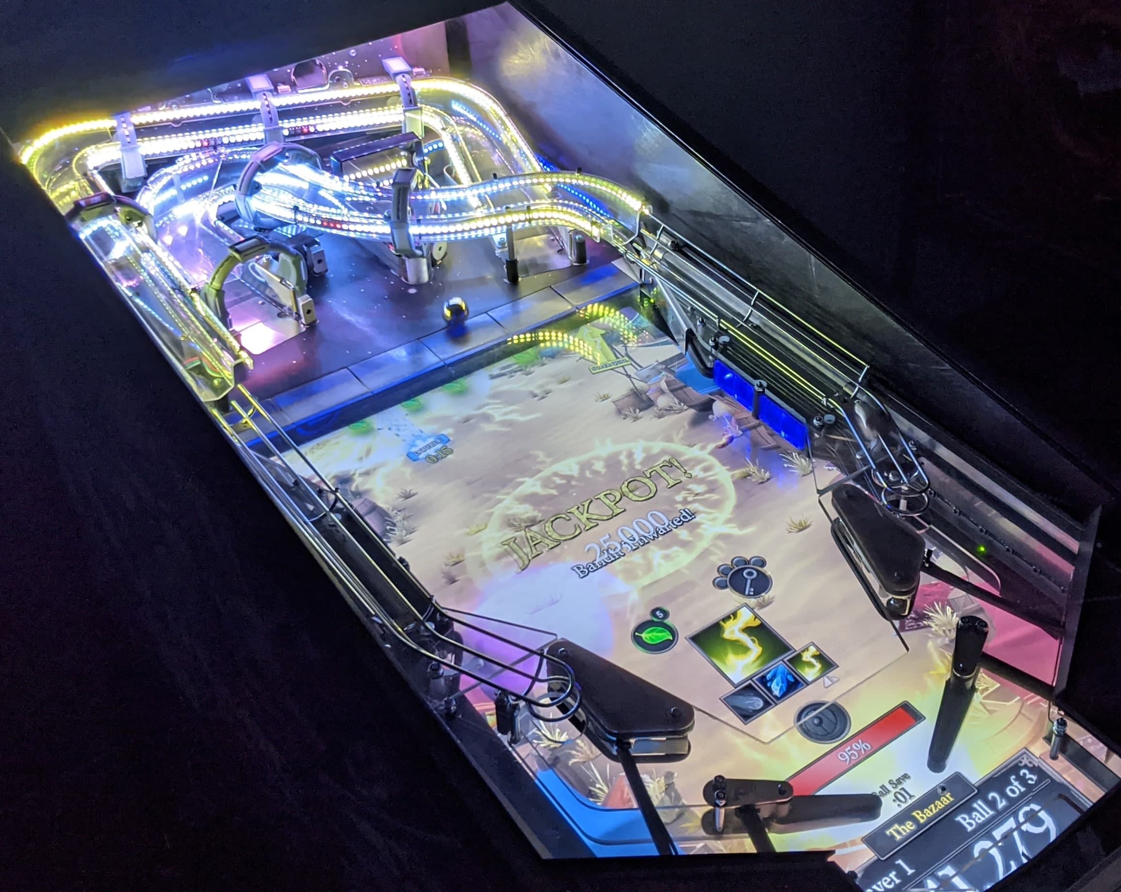 Illuminated pinball machine with colorful lights and Jackpot themed playfield