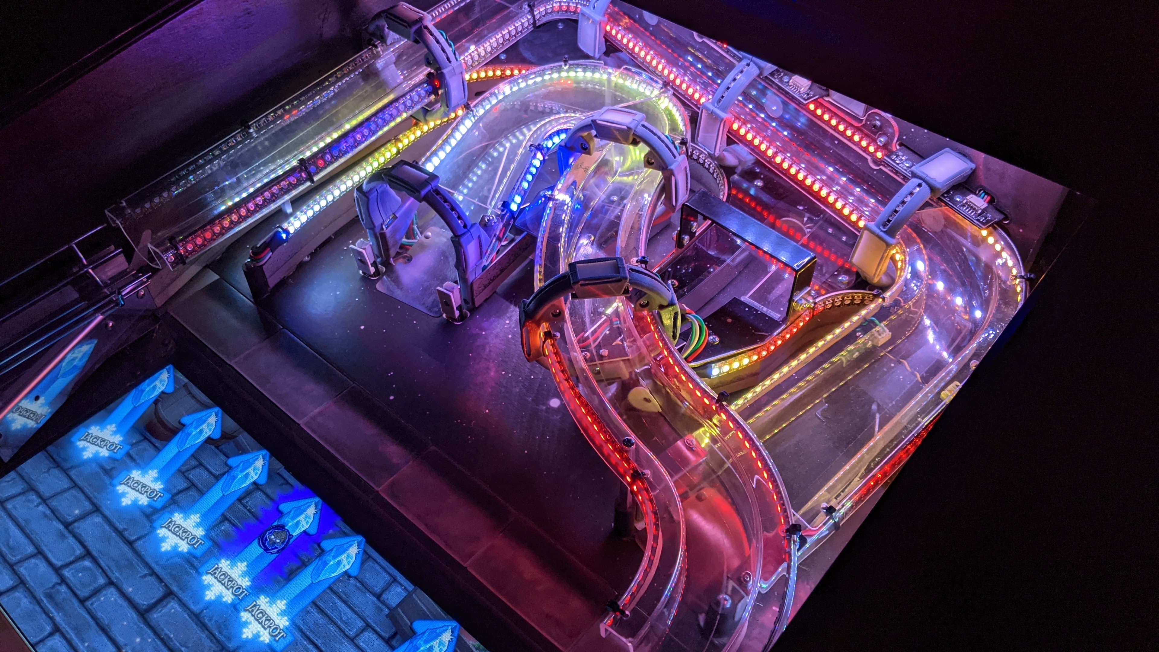 Colorful LED-lit marble run with transparent tracks and winding paths