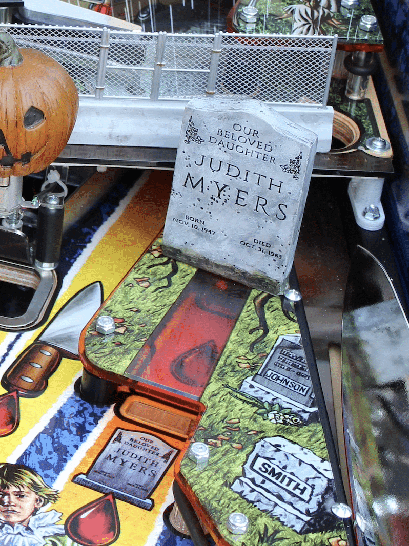 Halloween-themed pinball machine with tombstone for Judith Myers