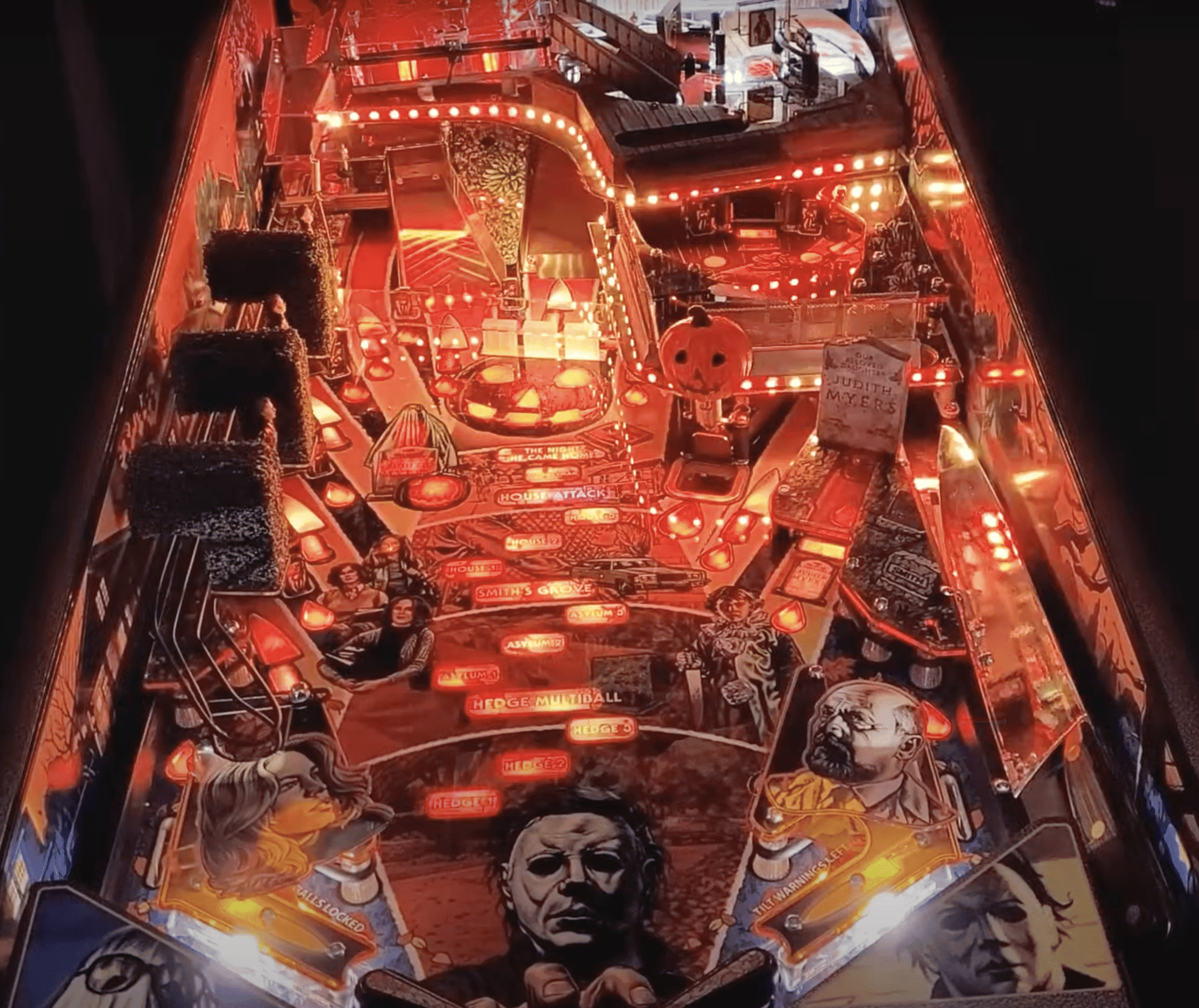 Halloween-themed pinball machine with glowing pumpkins and spooky characters