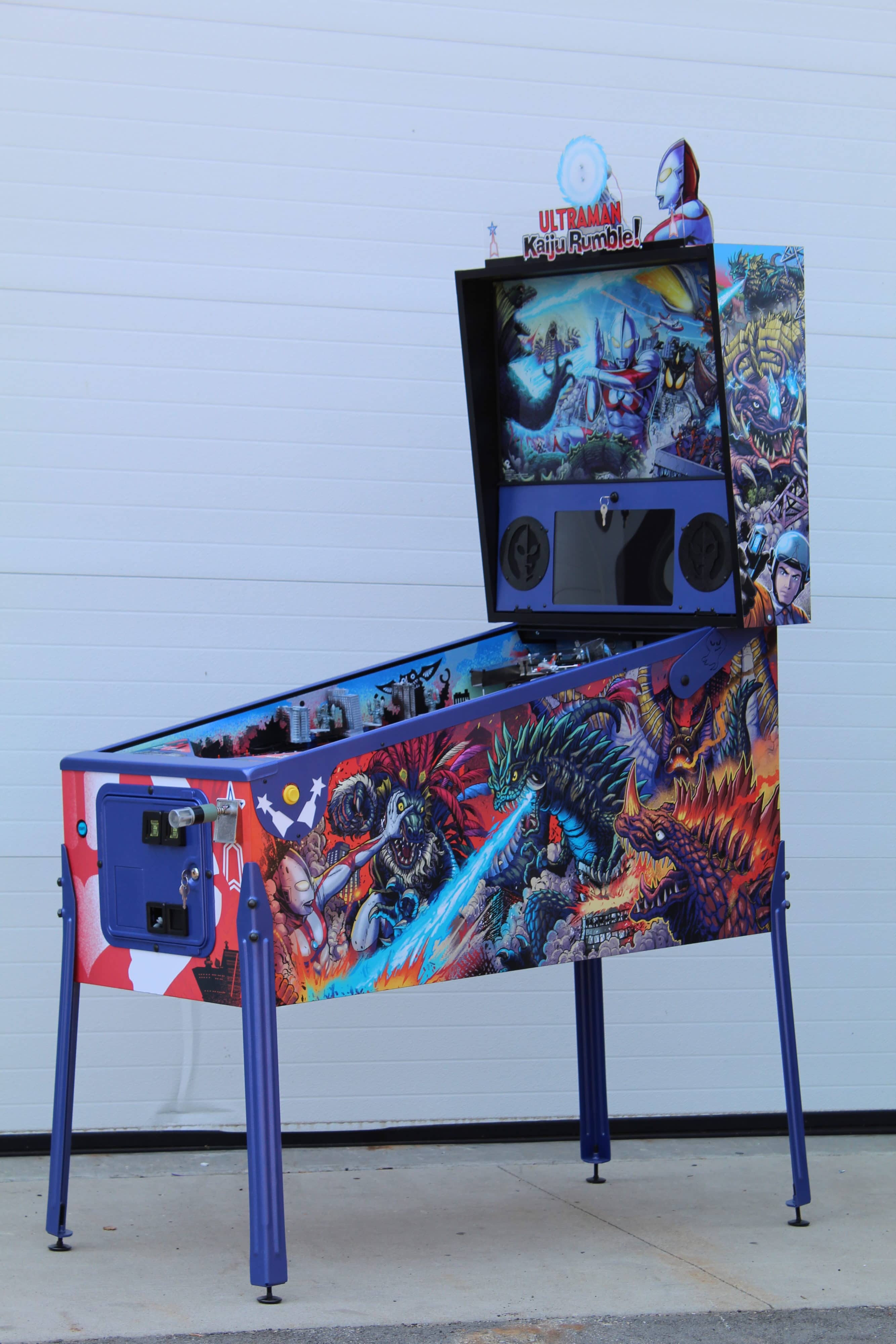 Ultraman-themed pinball machine with colorful kaiju battle scenes