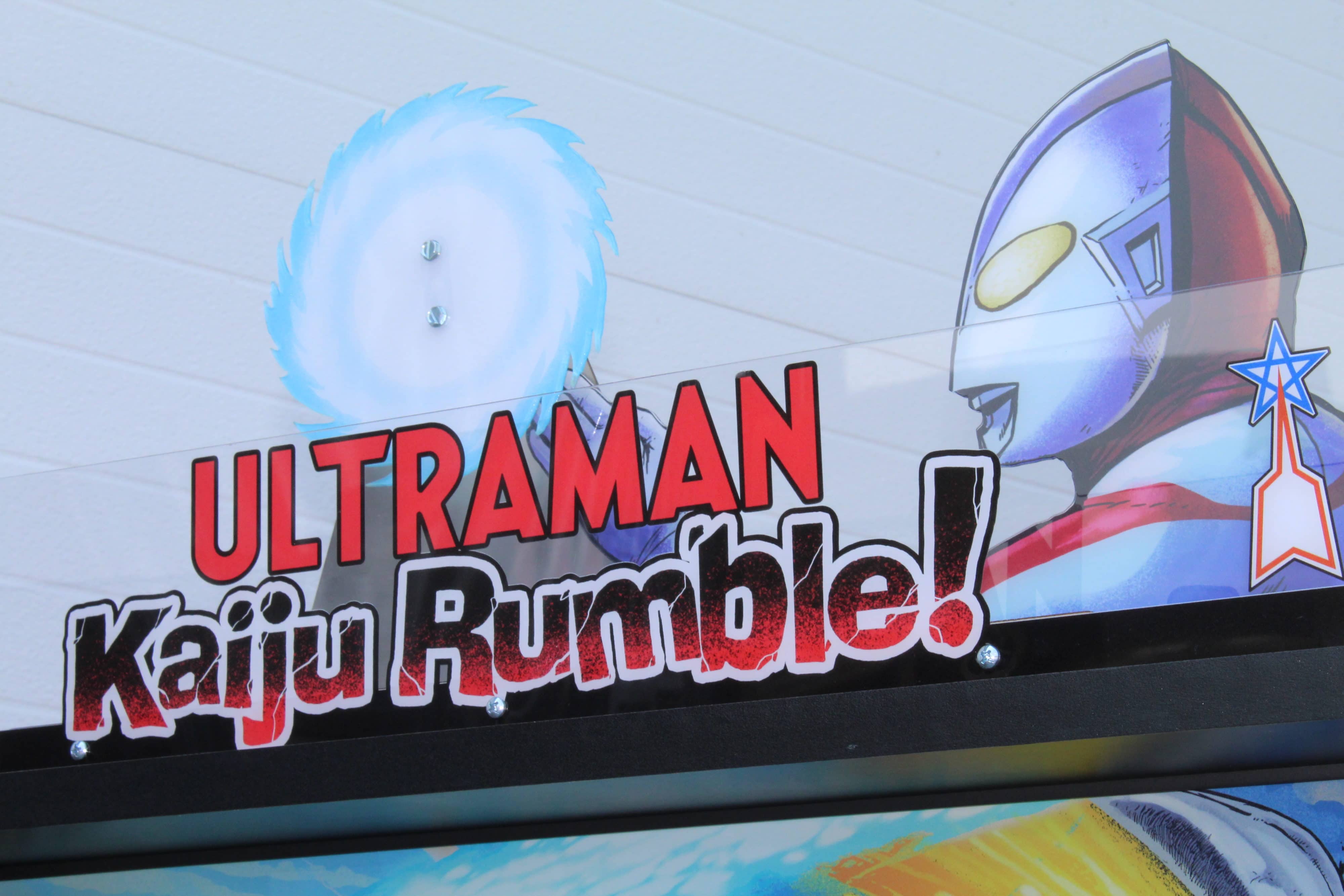 Ultraman Kaiju Rumble logo with blue energy sphere and superhero
