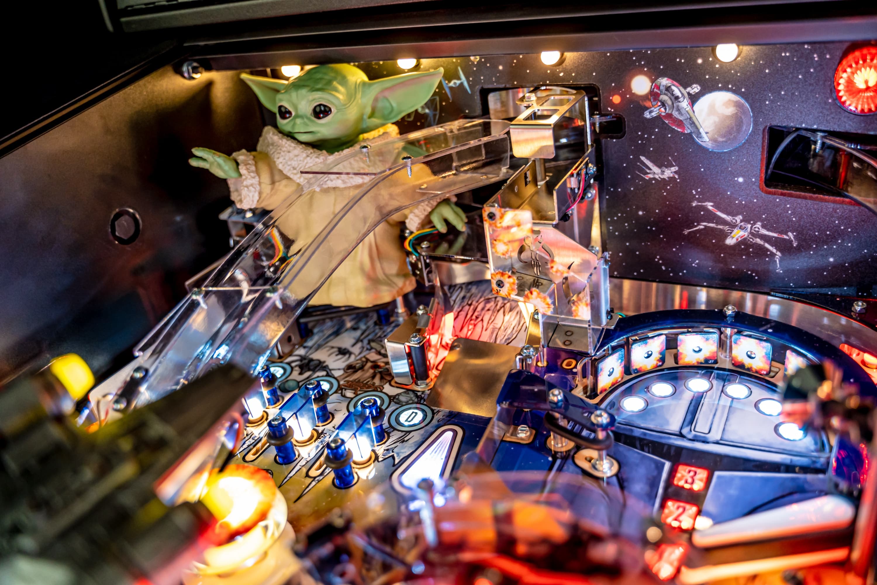 Star Wars pinball machine with Grogu amid colorful lights and space backdrop