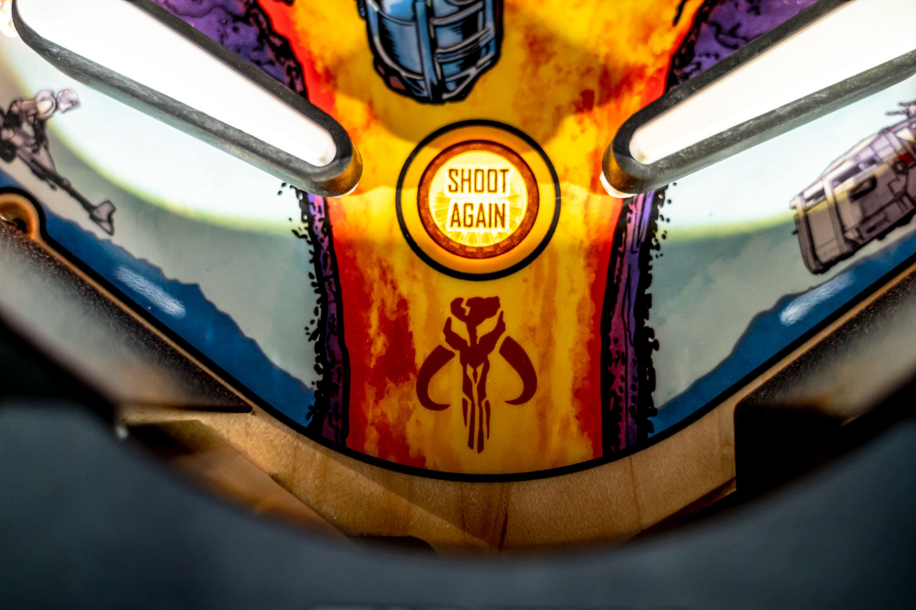 Pinball machine detail with "Shoot Again" button and Mandalorian symbol