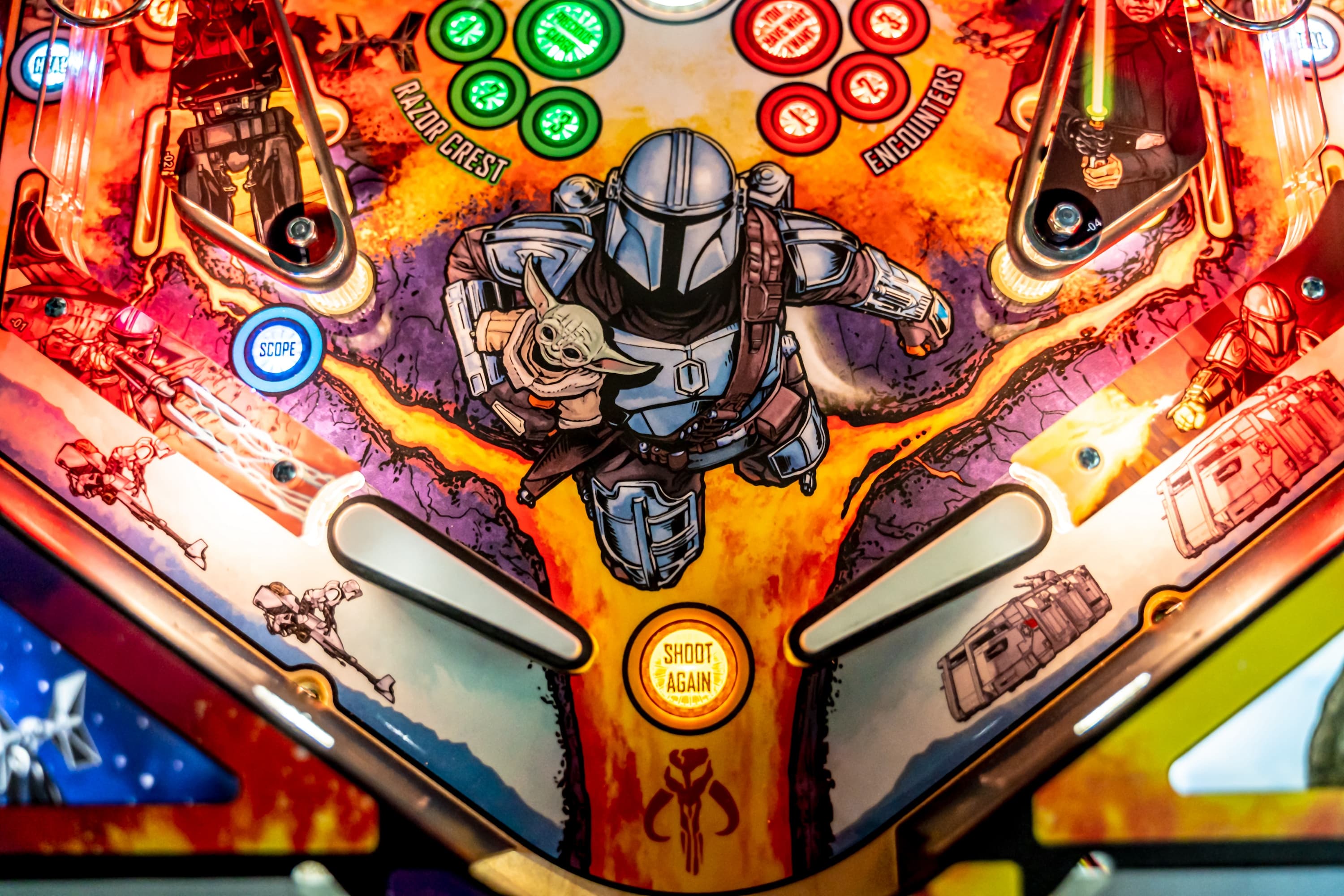 Mandalorian pinball machine with colorful design and central character holding Grogu