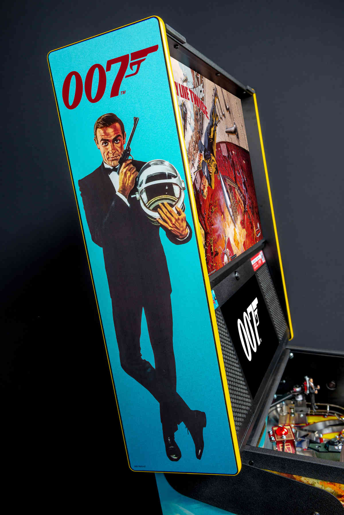 James Bond 007 poster with agent in tuxedo holding gun and helmet