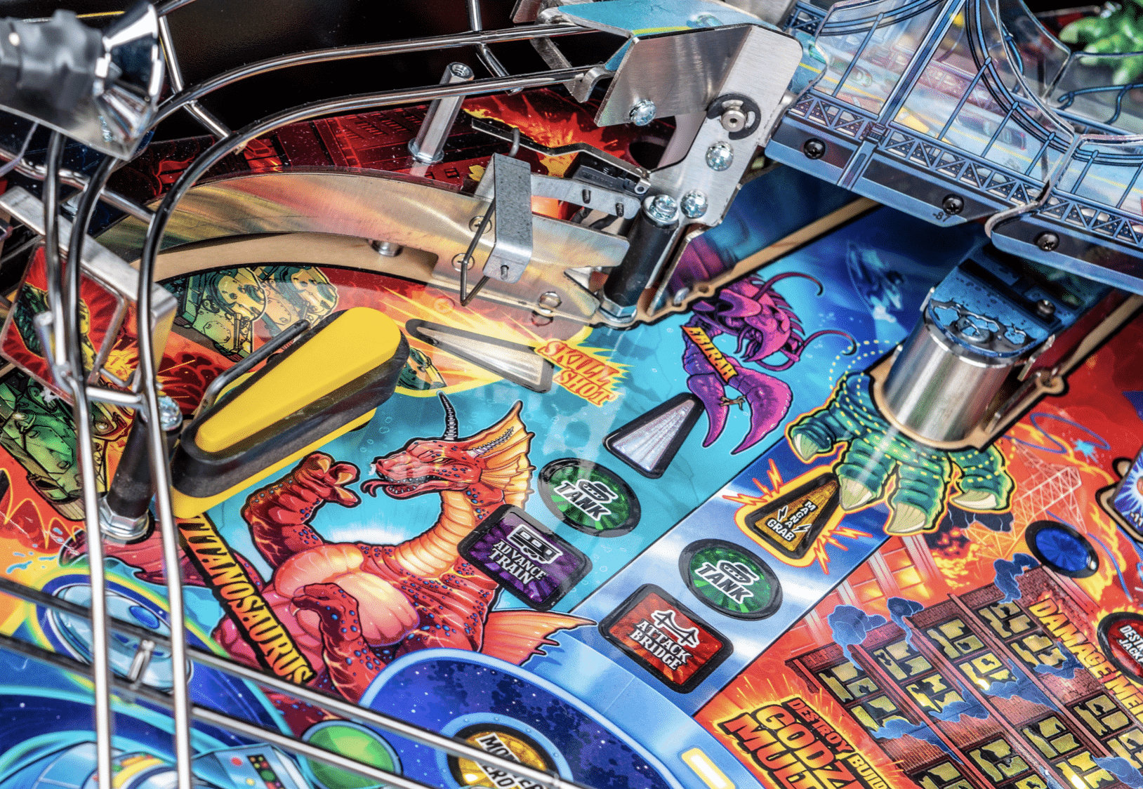 Colorful pinball machine playfield with fantasy creatures and mechanical components