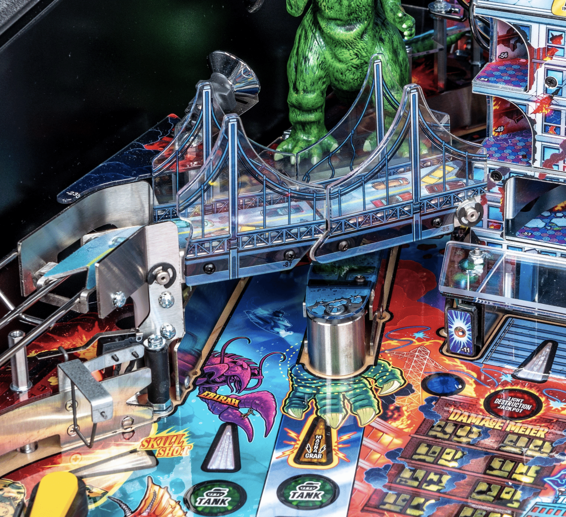 Colorful pinball machine with bridge, green monster, and sci-fi themed elements