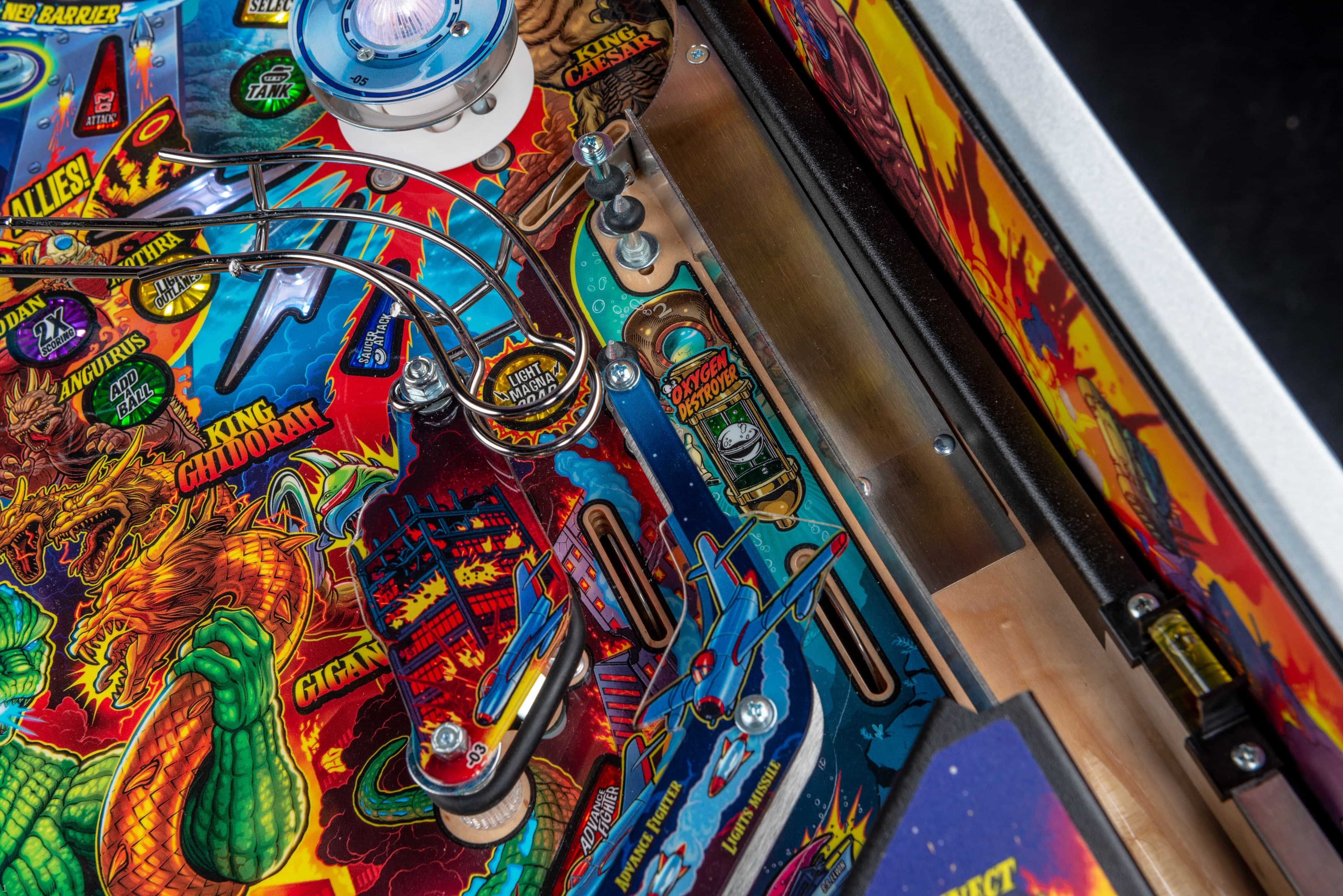 Colorful pinball machine with dragons, robots, and vibrant game artwork